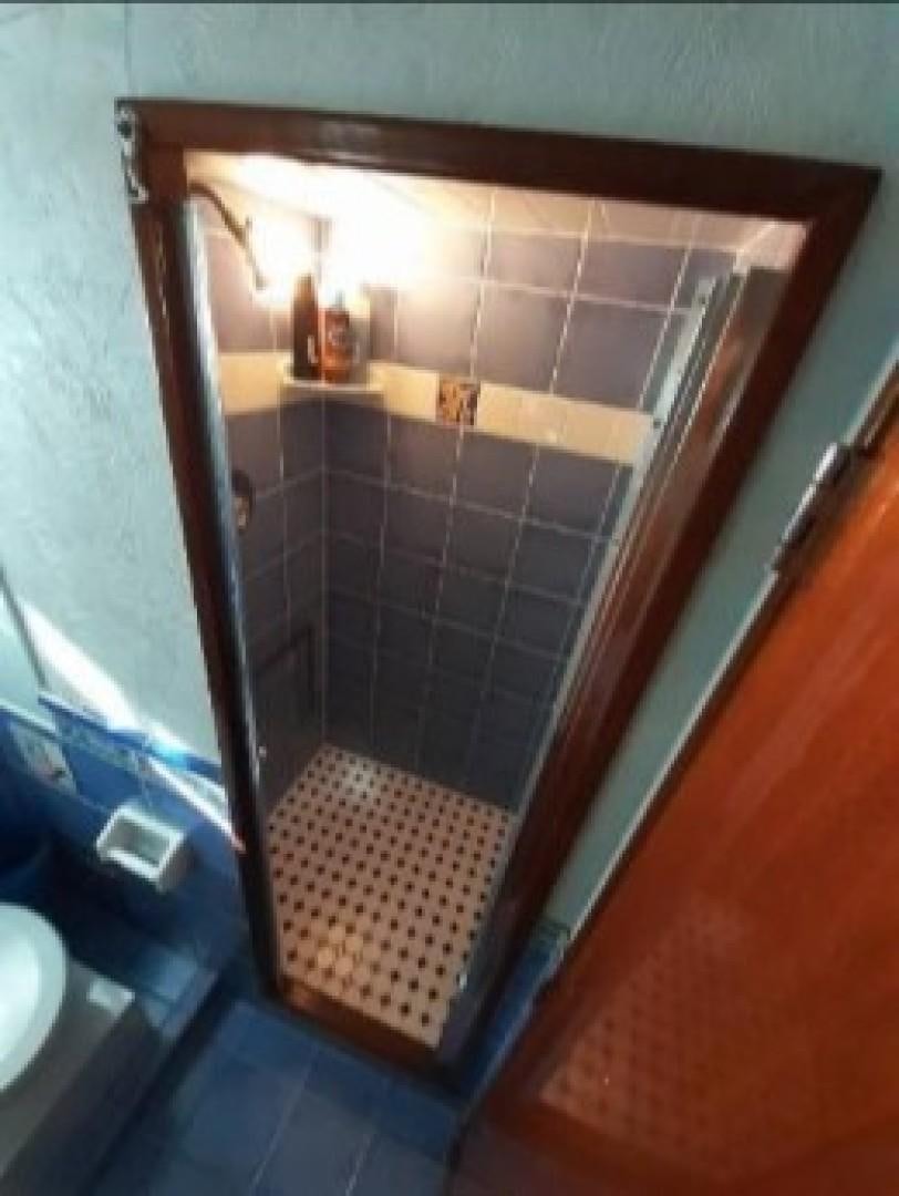 a bathroom with a tile wall aboard FANTASEA Yacht for Sale