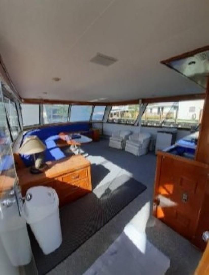 a room with a table and chairs aboard FANTASEA Yacht for Sale