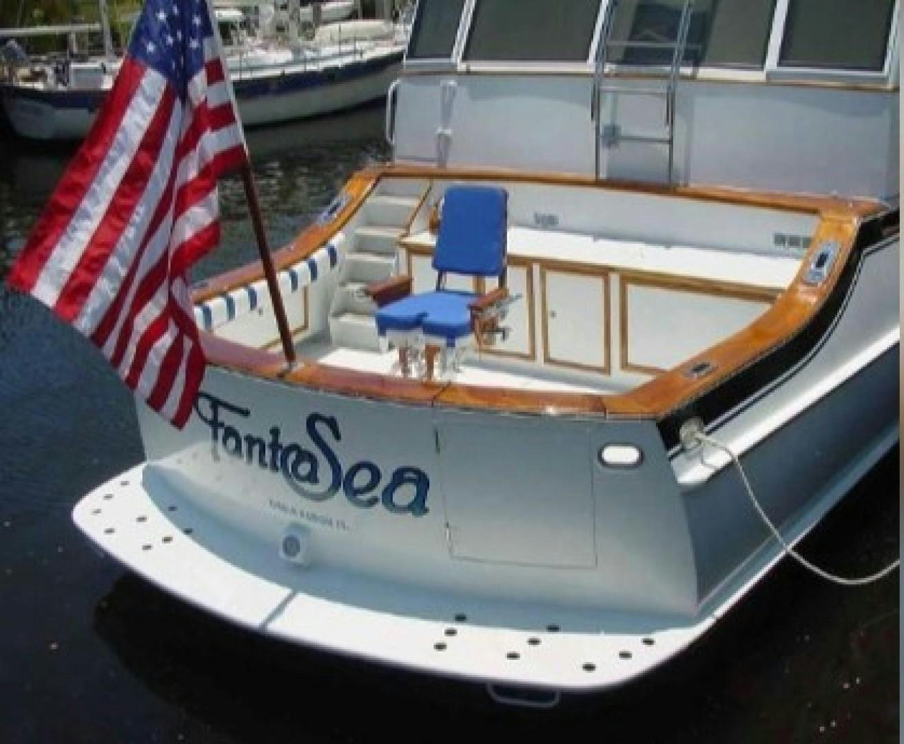 a boat with a flag on the front aboard FANTASEA Yacht for Sale