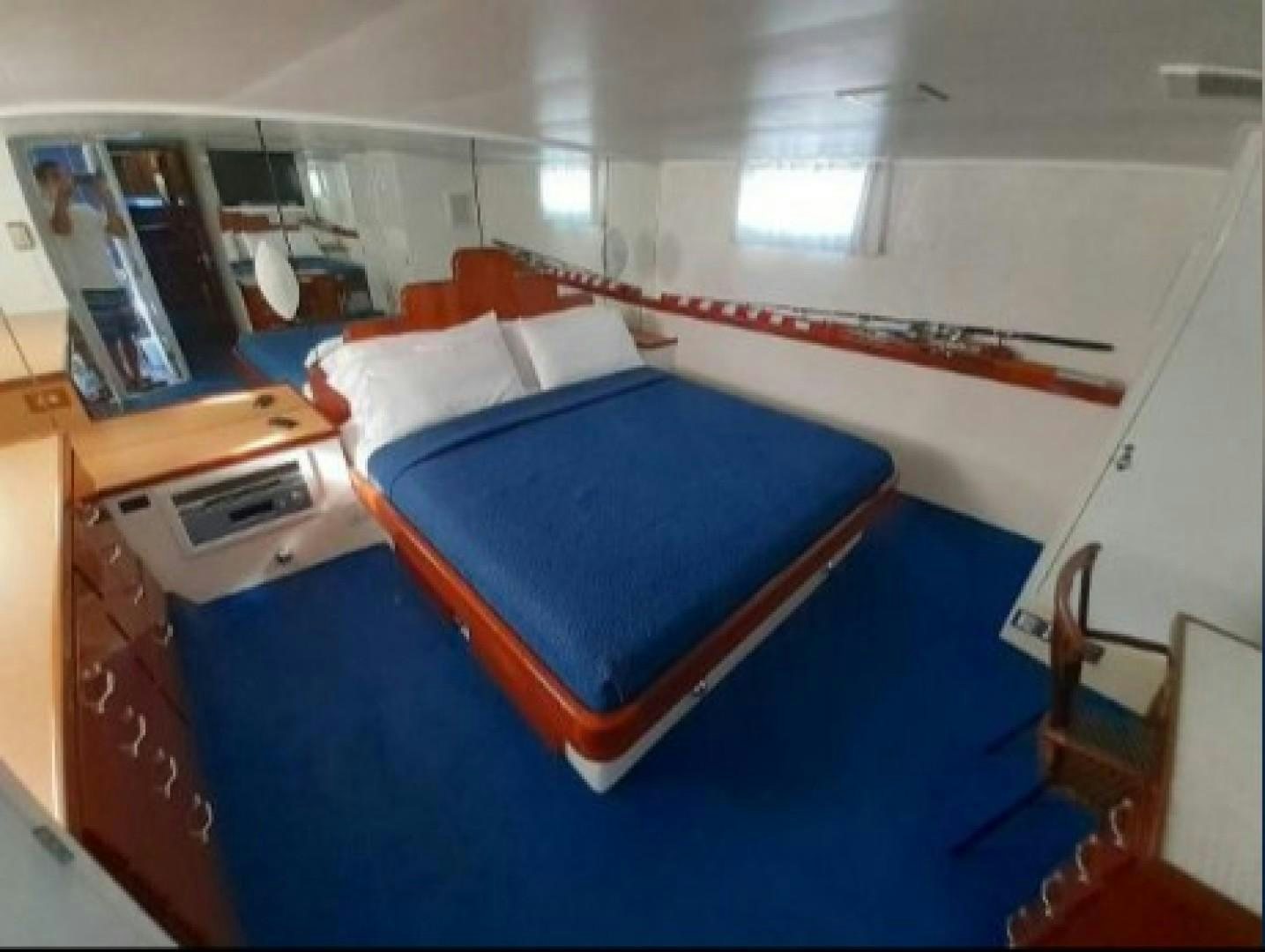 a room with a bed and a desk aboard FANTASEA Yacht for Sale