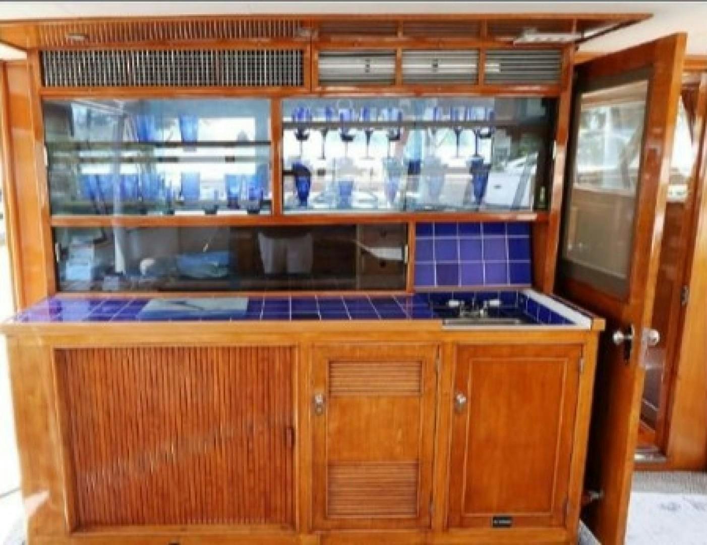 a kitchen with a bar aboard FANTASEA Yacht for Sale