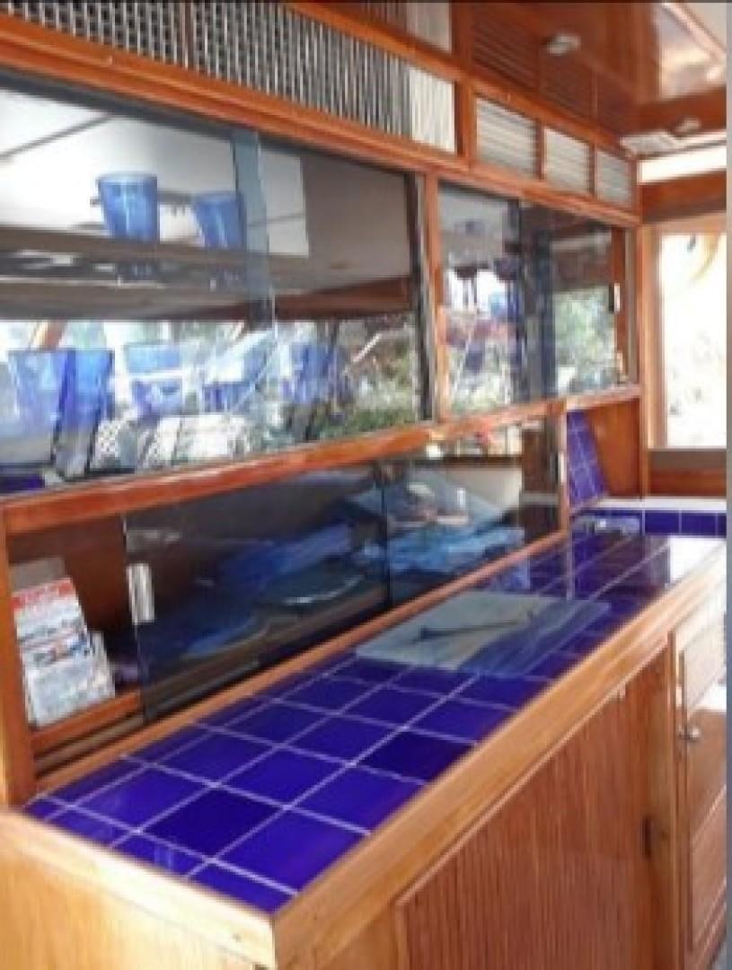 a room with a table and chairs aboard FANTASEA Yacht for Sale