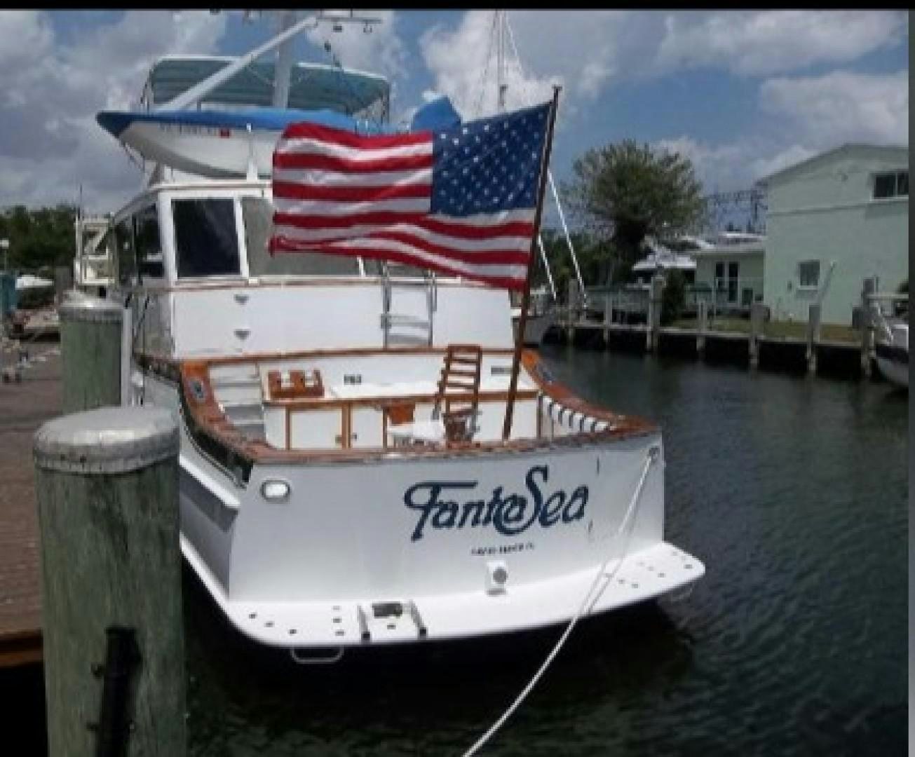 a boat with a flag on it aboard FANTASEA Yacht for Sale