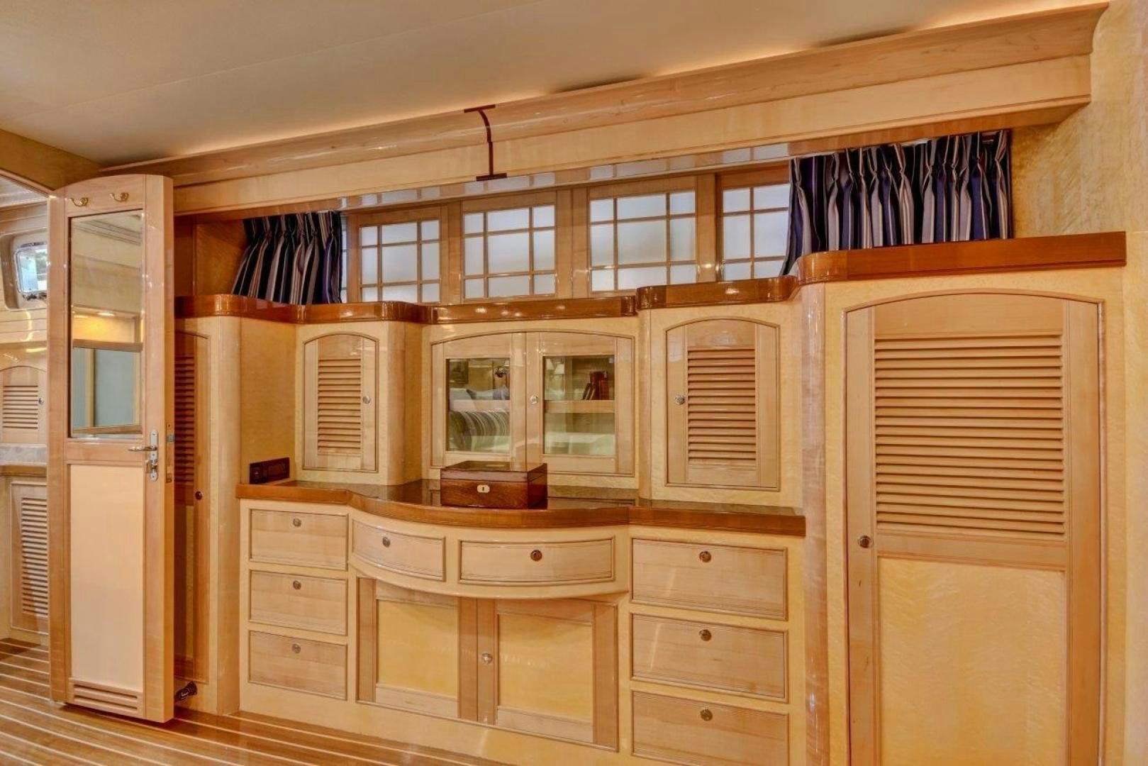 a room with a cabinet and a window aboard INEVITABLE Yacht for Sale