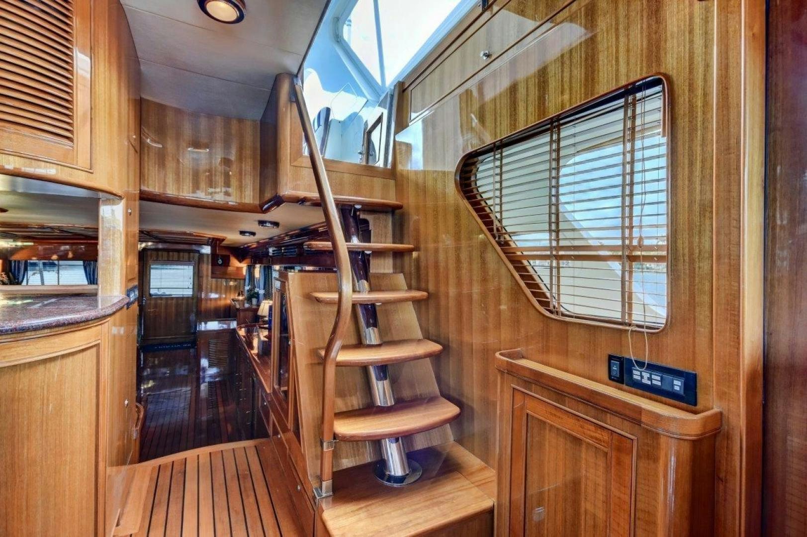 a wooden staircase in a house aboard INEVITABLE Yacht for Sale