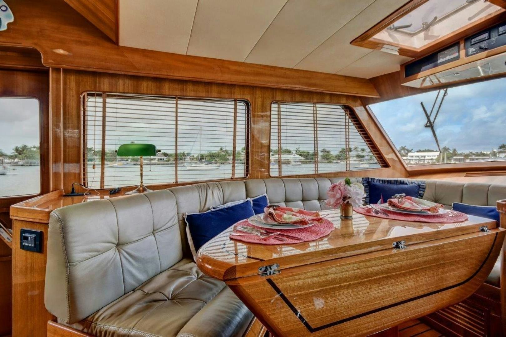 a living room with a couch and a table aboard INEVITABLE Yacht for Sale