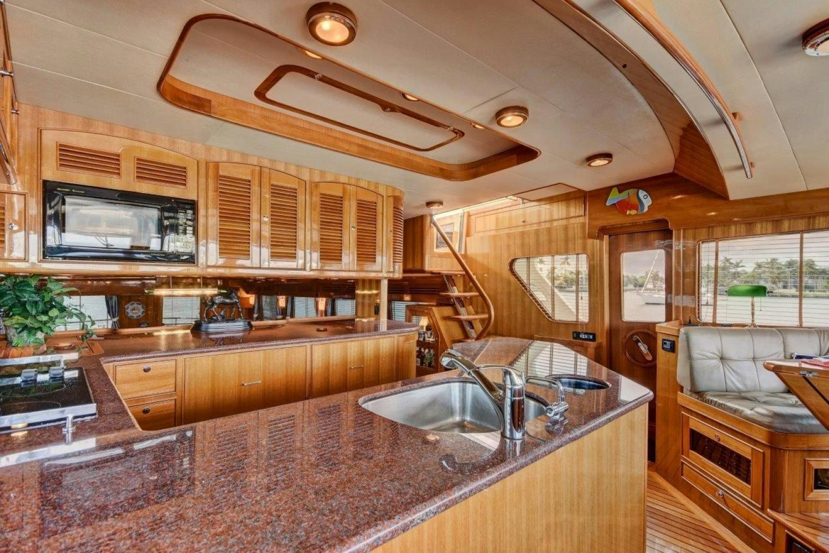 a kitchen with wooden cabinets aboard INEVITABLE Yacht for Sale