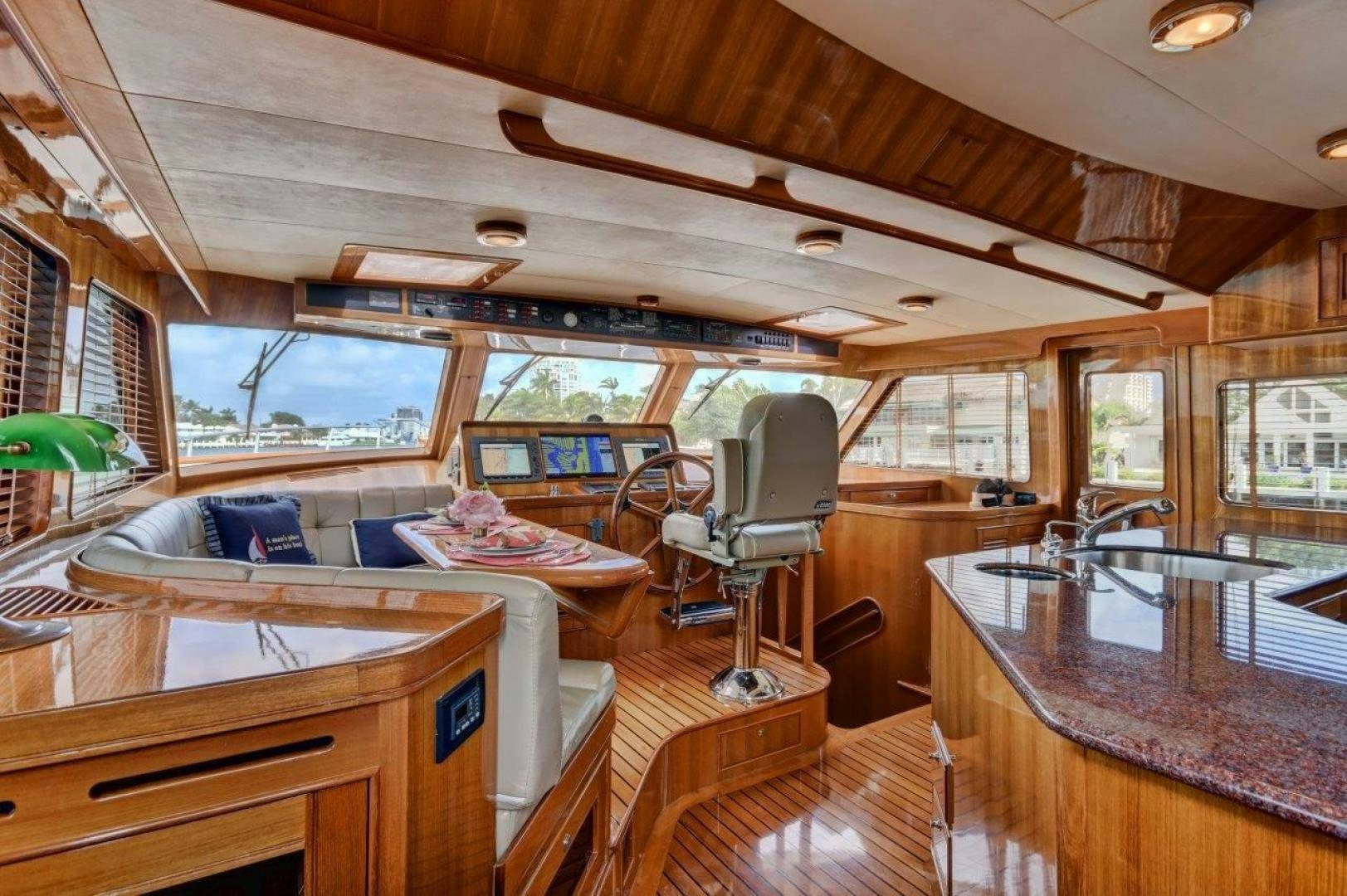 a cabin with a bed and a table aboard INEVITABLE Yacht for Sale