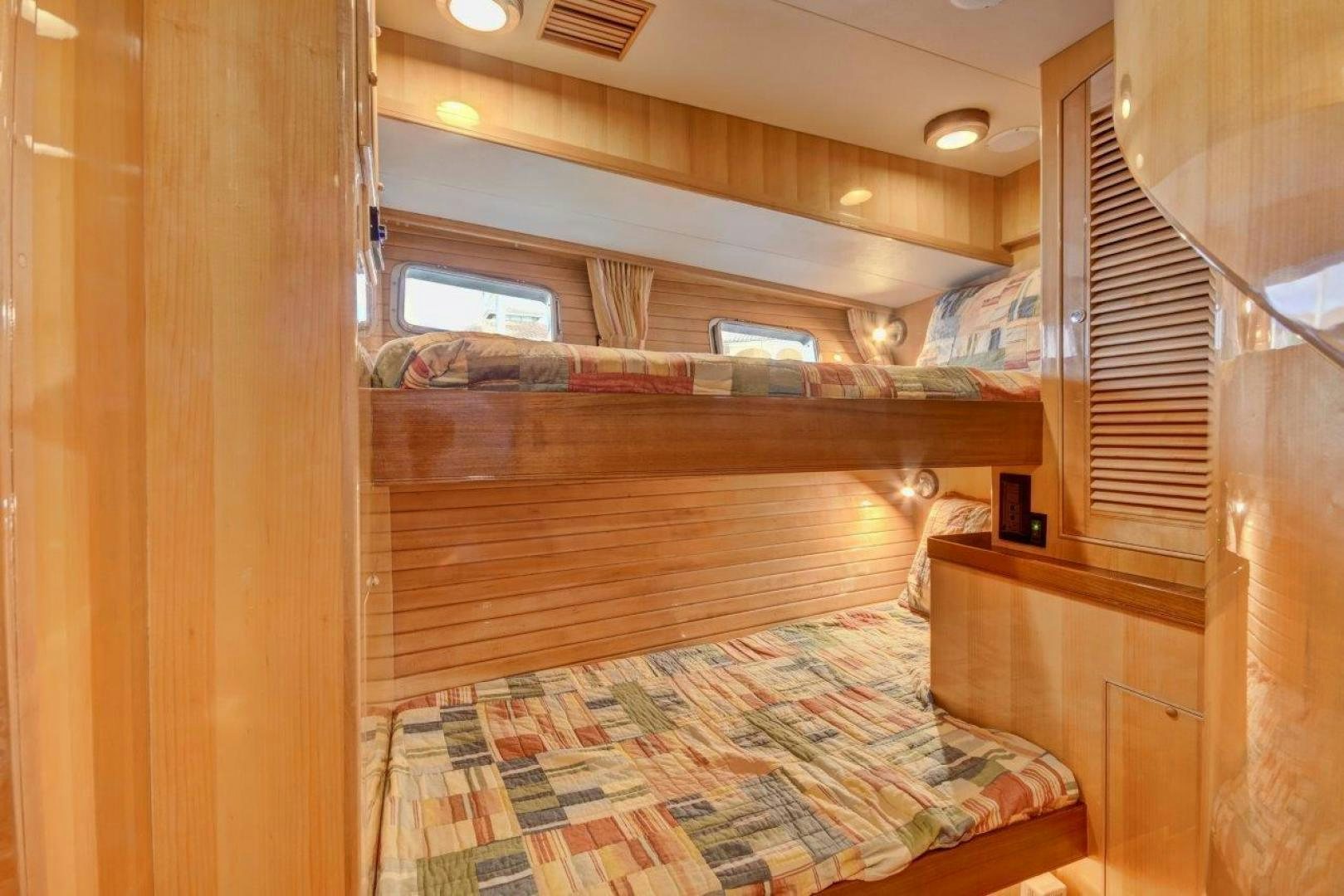a bed with a wood frame aboard INEVITABLE Yacht for Sale