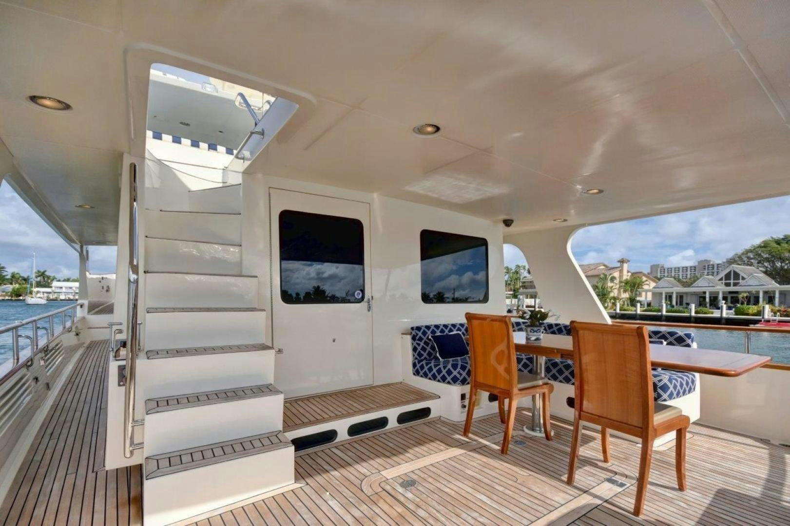 a room with a bed and a table and chairs aboard INEVITABLE Yacht for Sale