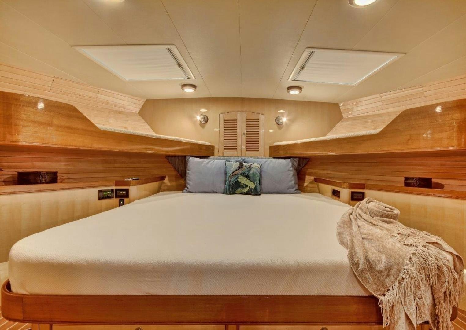 a room with a bed and a wood floor aboard INEVITABLE Yacht for Sale