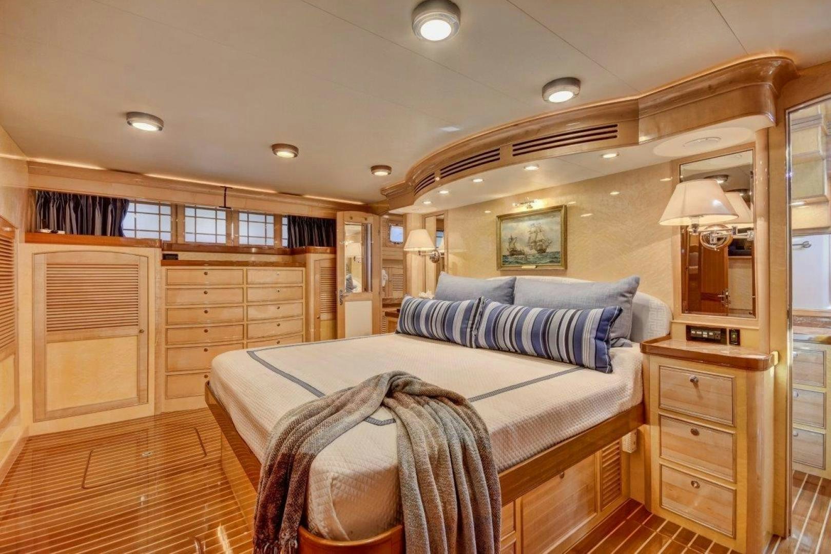 a bedroom with a bed and a desk aboard INEVITABLE Yacht for Sale
