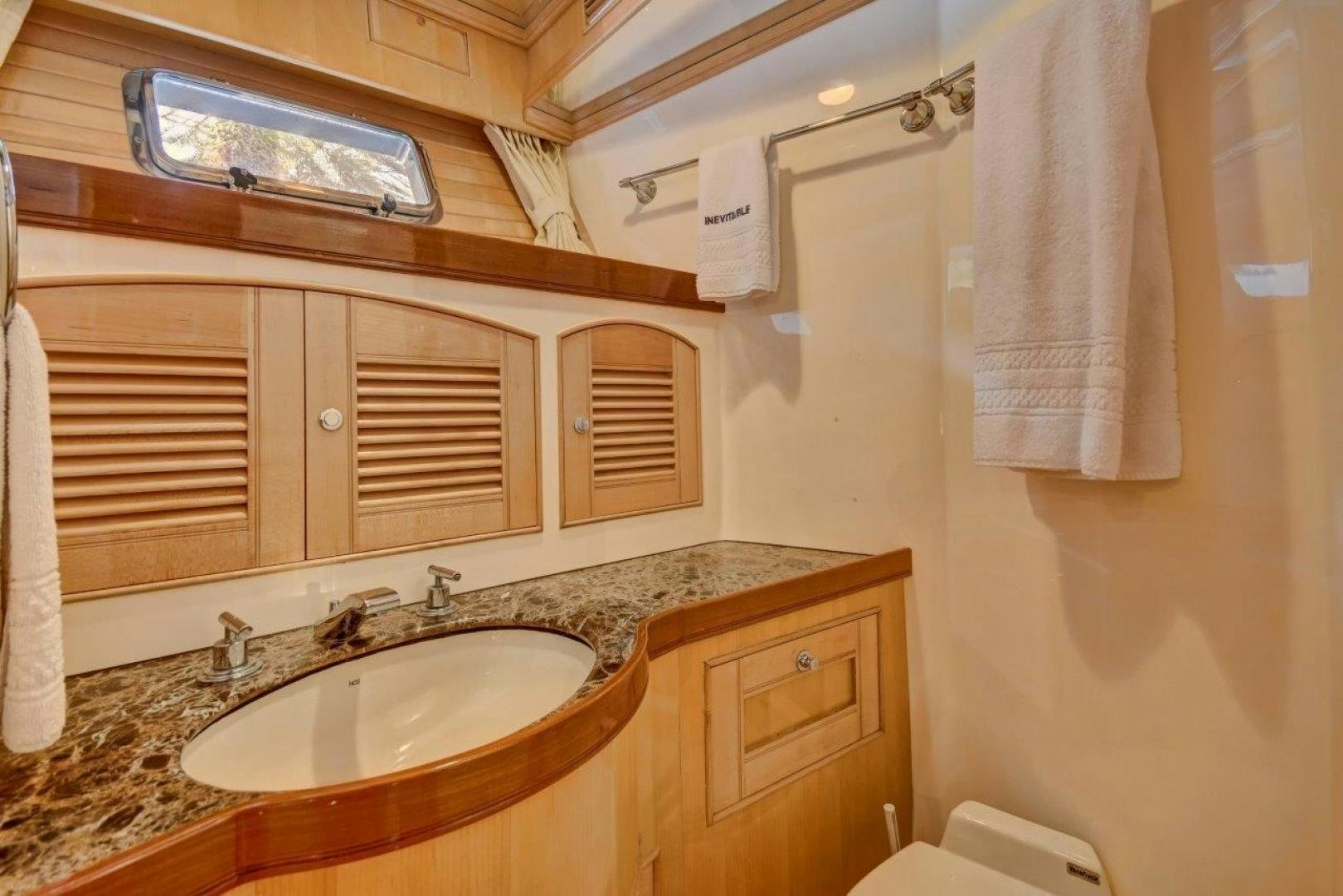 a bathroom with a sink and a mirror aboard INEVITABLE Yacht for Sale