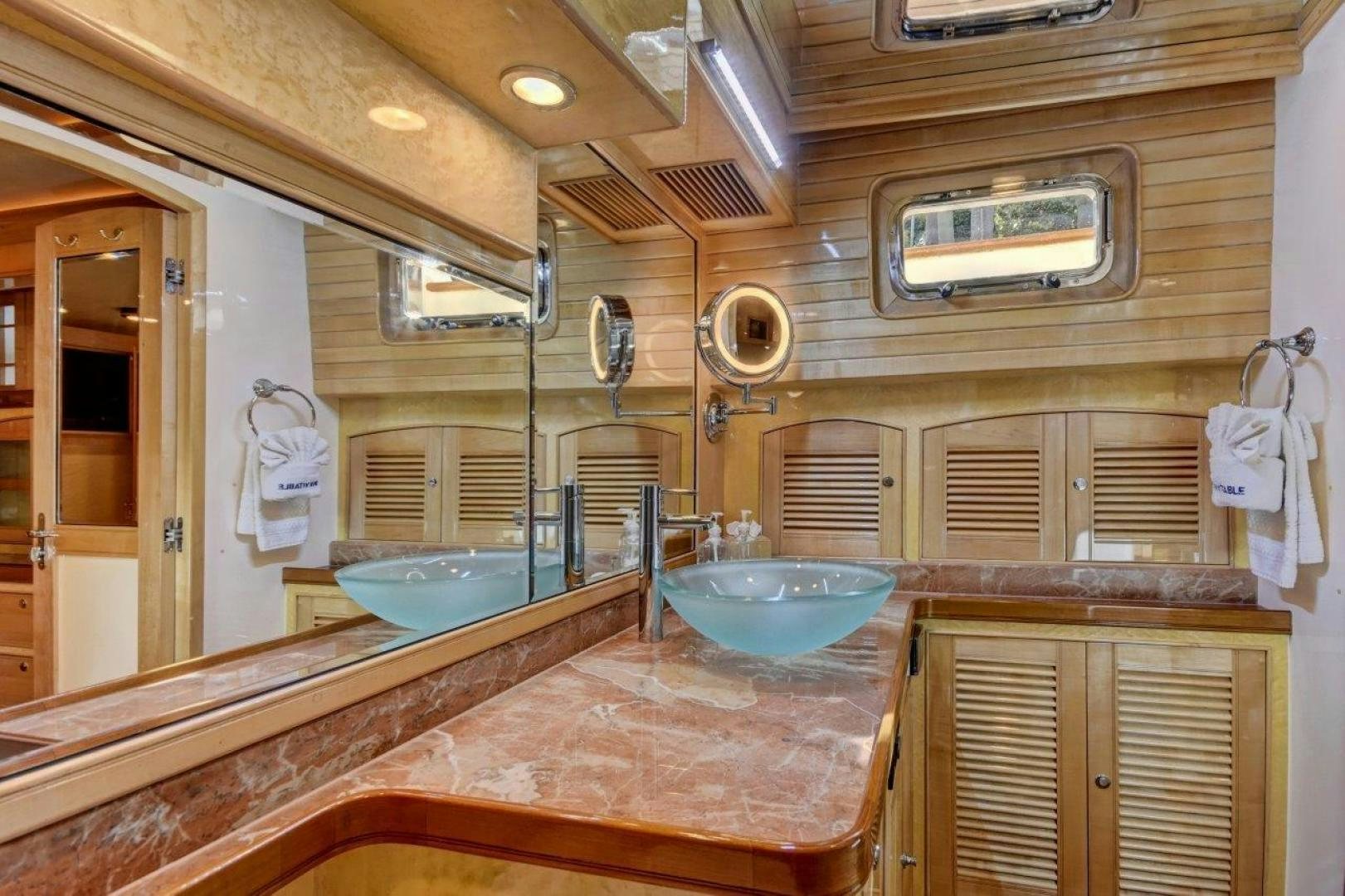 a bathroom with a sink and a mirror aboard INEVITABLE Yacht for Sale