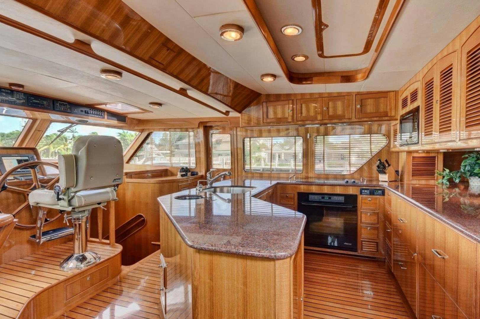 a large kitchen with wooden cabinets aboard INEVITABLE Yacht for Sale