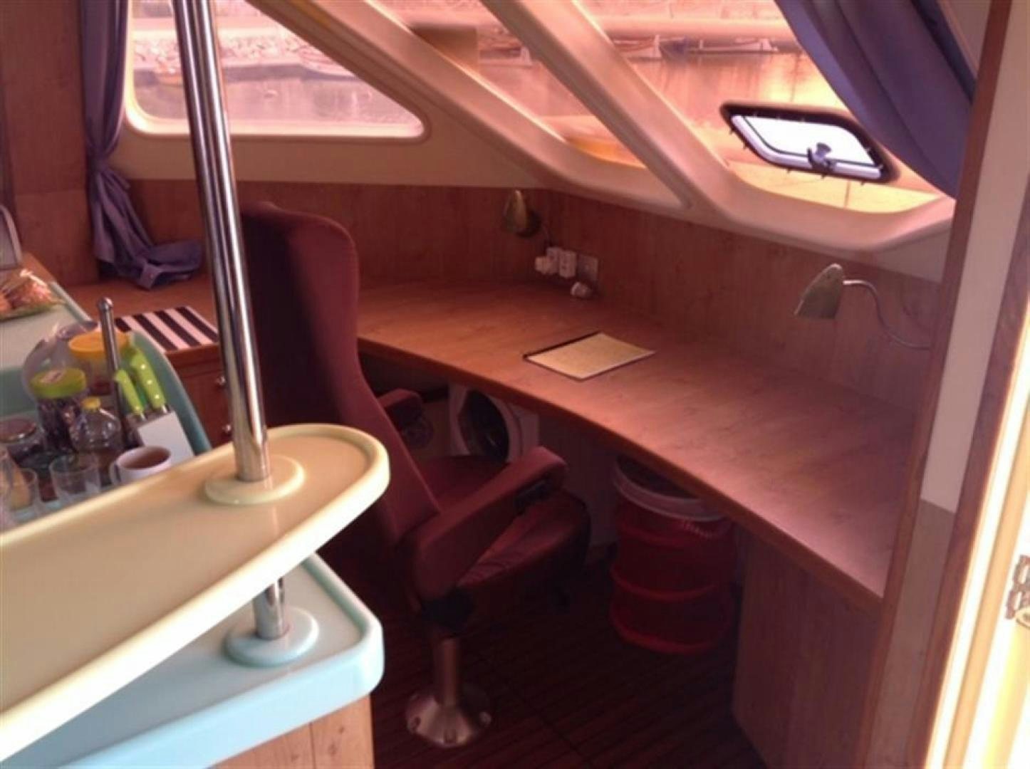 a room with a table and chairs aboard HELICAT RED Yacht for Sale
