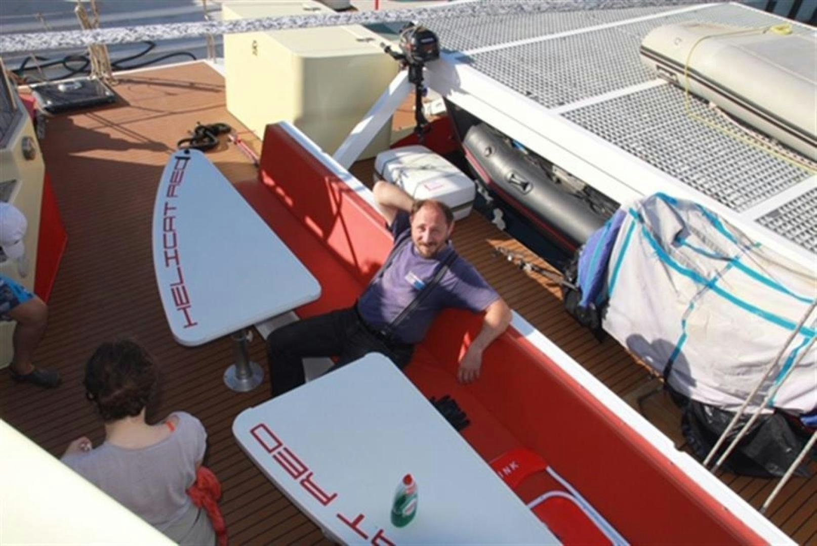 a person sitting on a boat aboard HELICAT RED Yacht for Sale