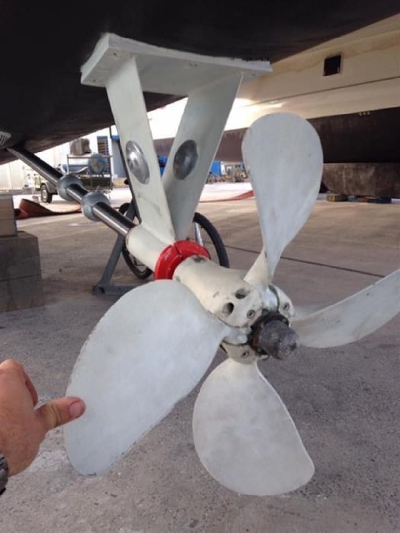 a hand holding a toy aboard HELICAT RED Yacht for Sale