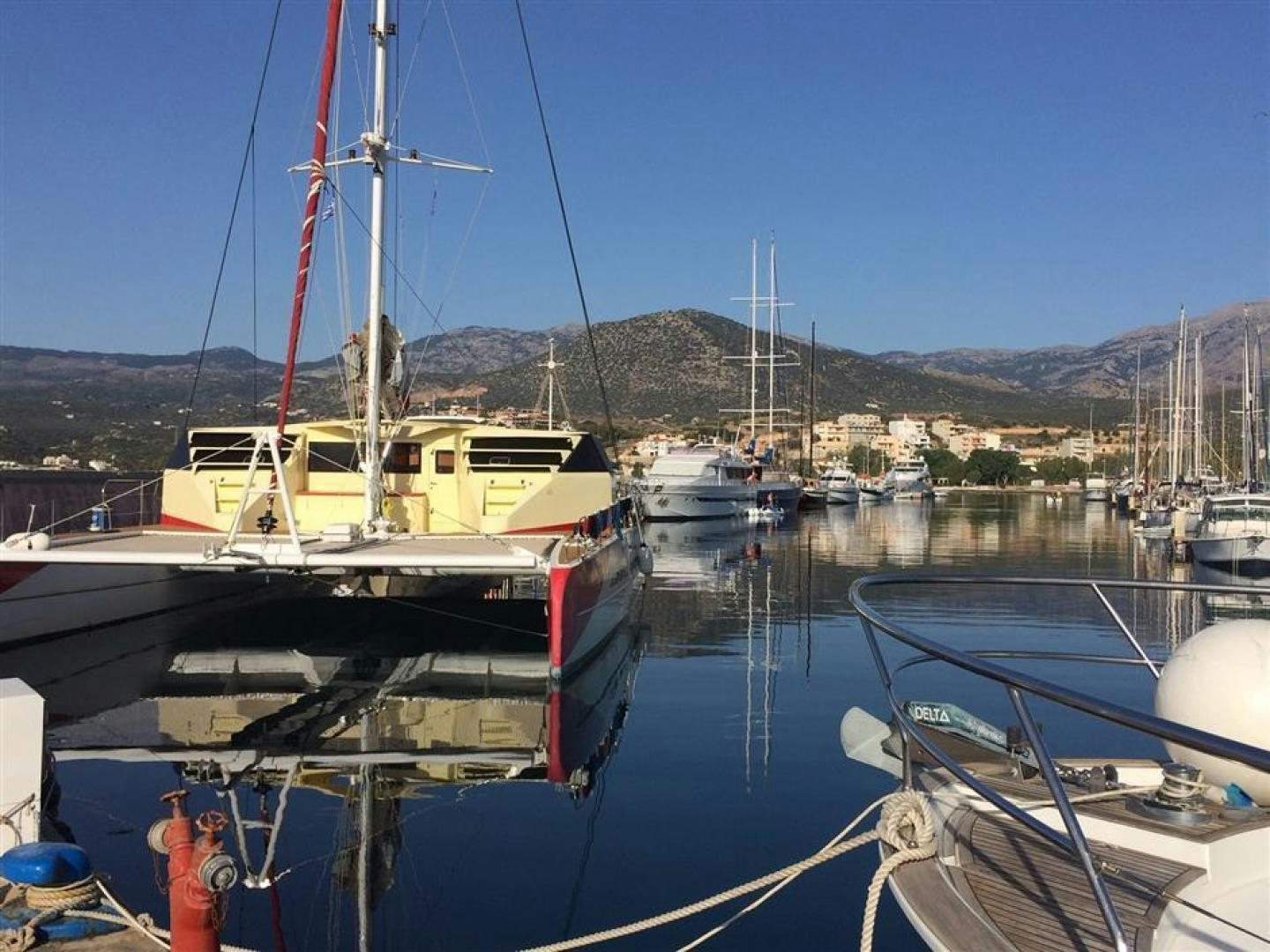 boats are parked in the harbor aboard HELICAT RED Yacht for Sale