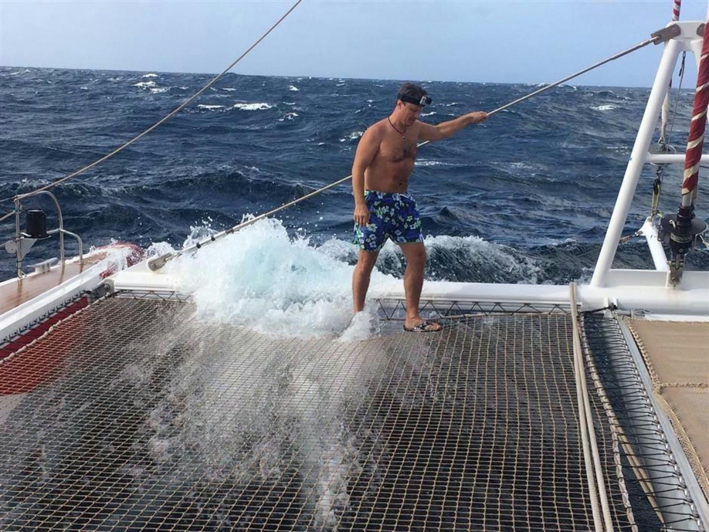a man standing on a boat aboard HELICAT RED Yacht for Sale