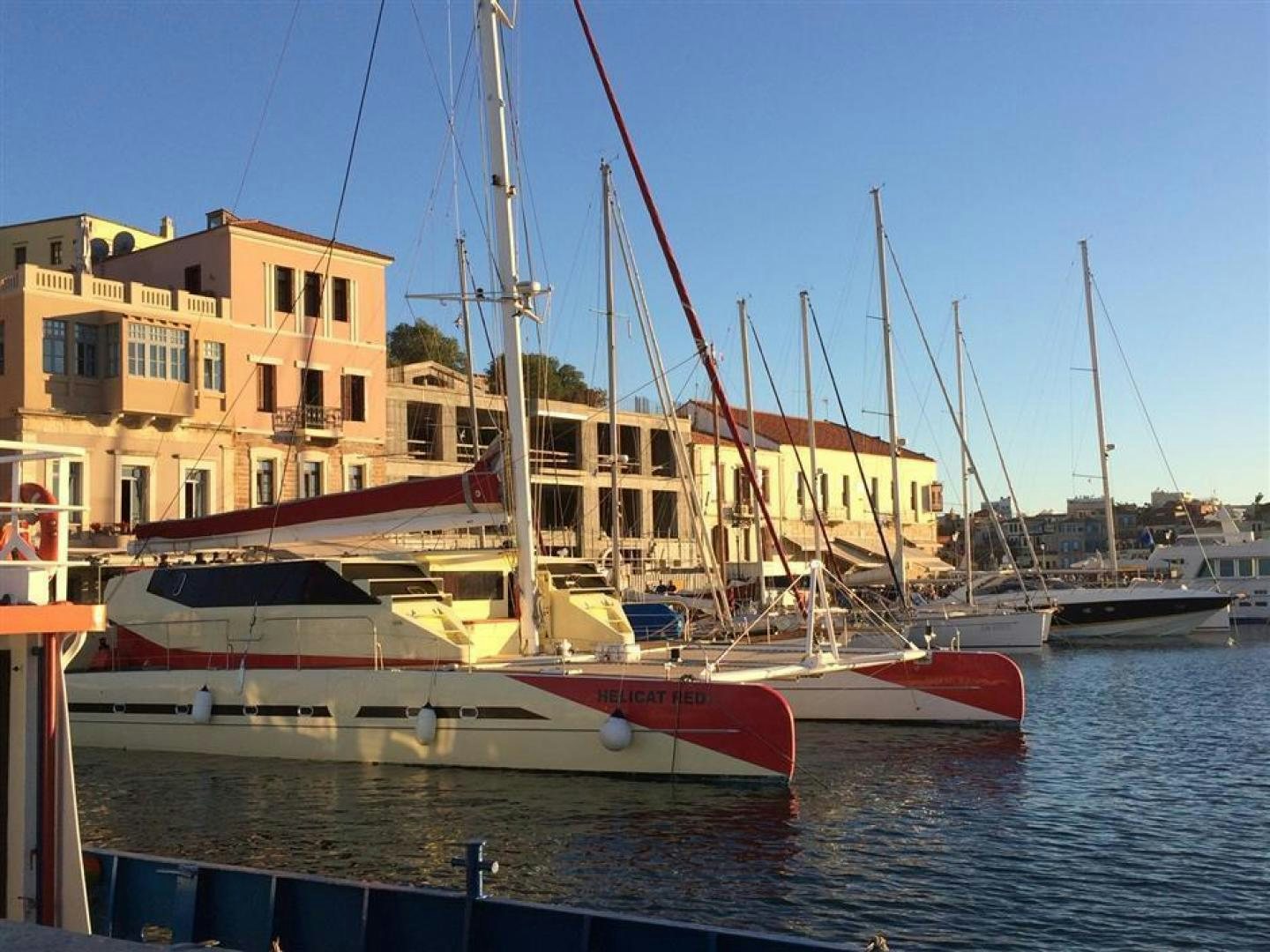 a boat docked at a pier aboard HELICAT RED Yacht for Sale