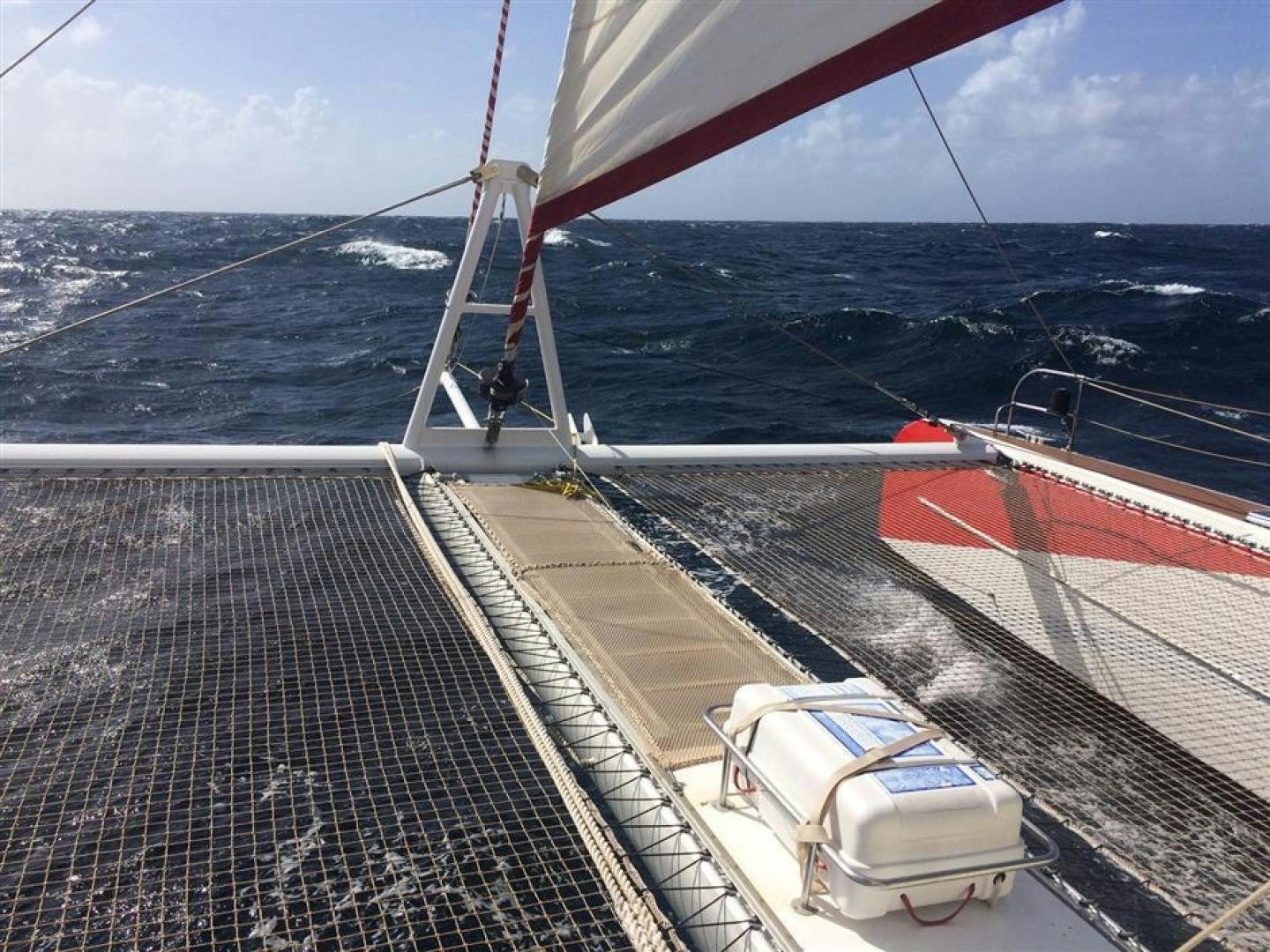 a person on a sailboat aboard HELICAT RED Yacht for Sale