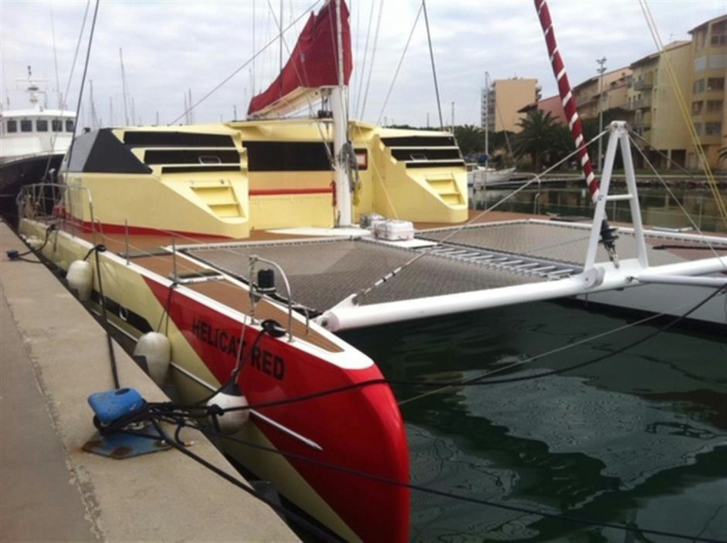 a boat docked at a pier aboard HELICAT RED Yacht for Sale