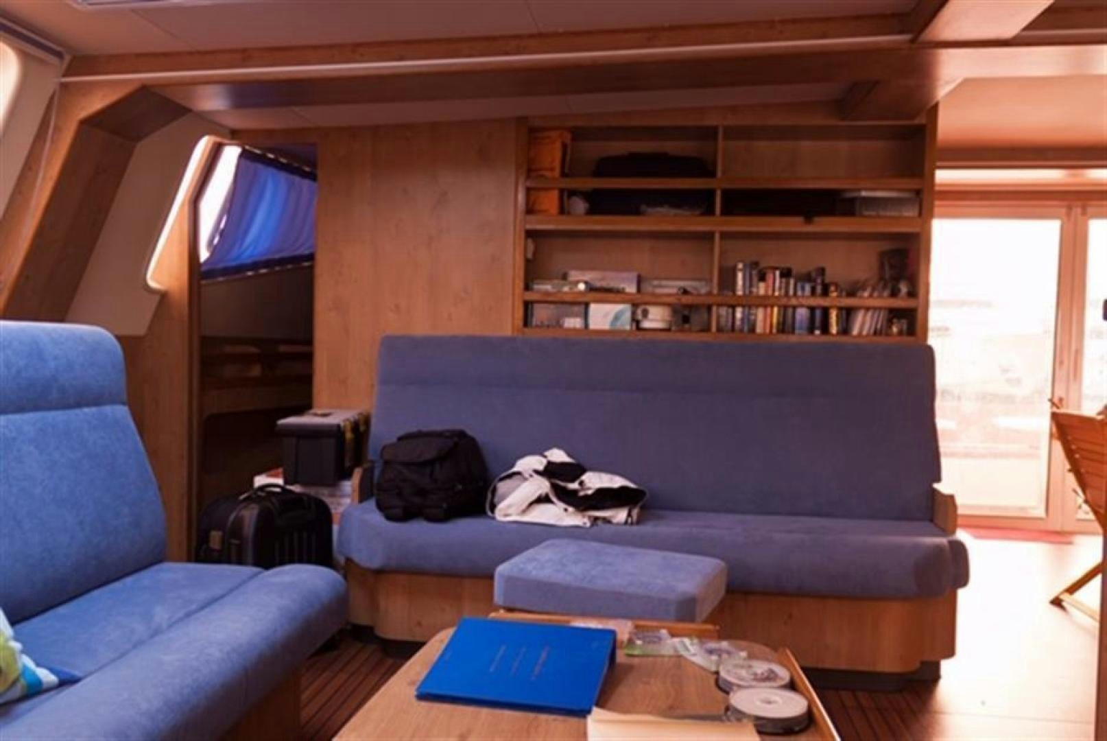 a living room with a couch and a table aboard HELICAT RED Yacht for Sale