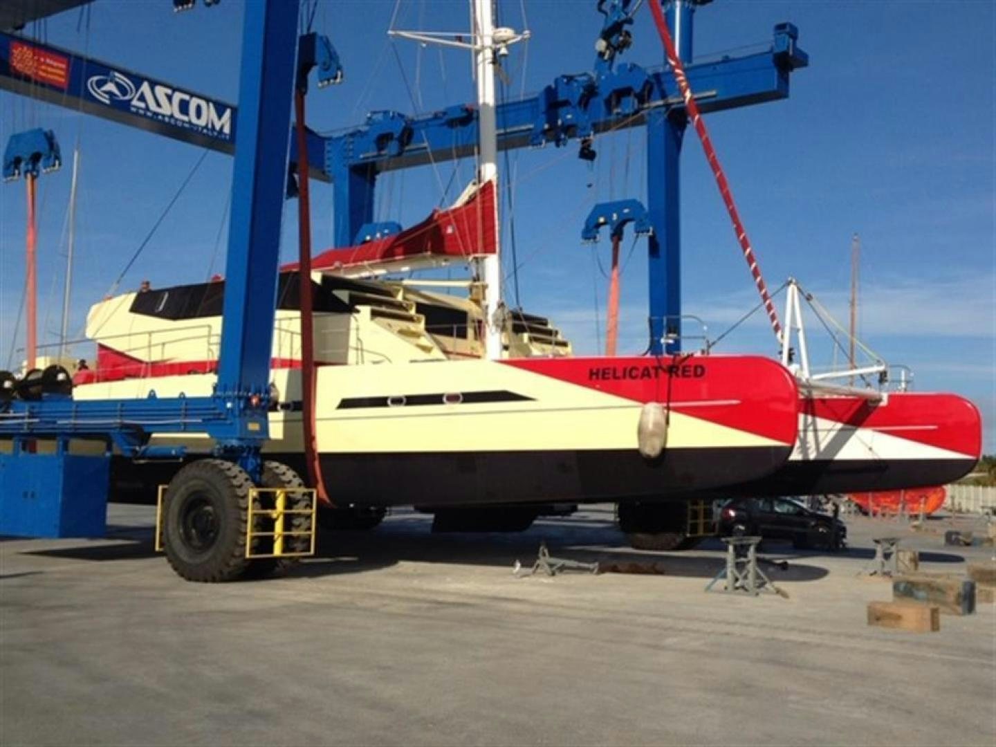 a red and white boat on a trailer aboard HELICAT RED Yacht for Sale