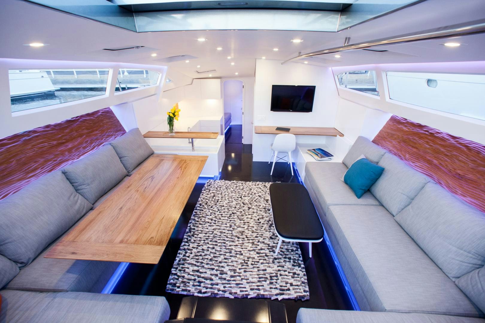 a living room with a couch and a table aboard AANDEEL Yacht for Sale