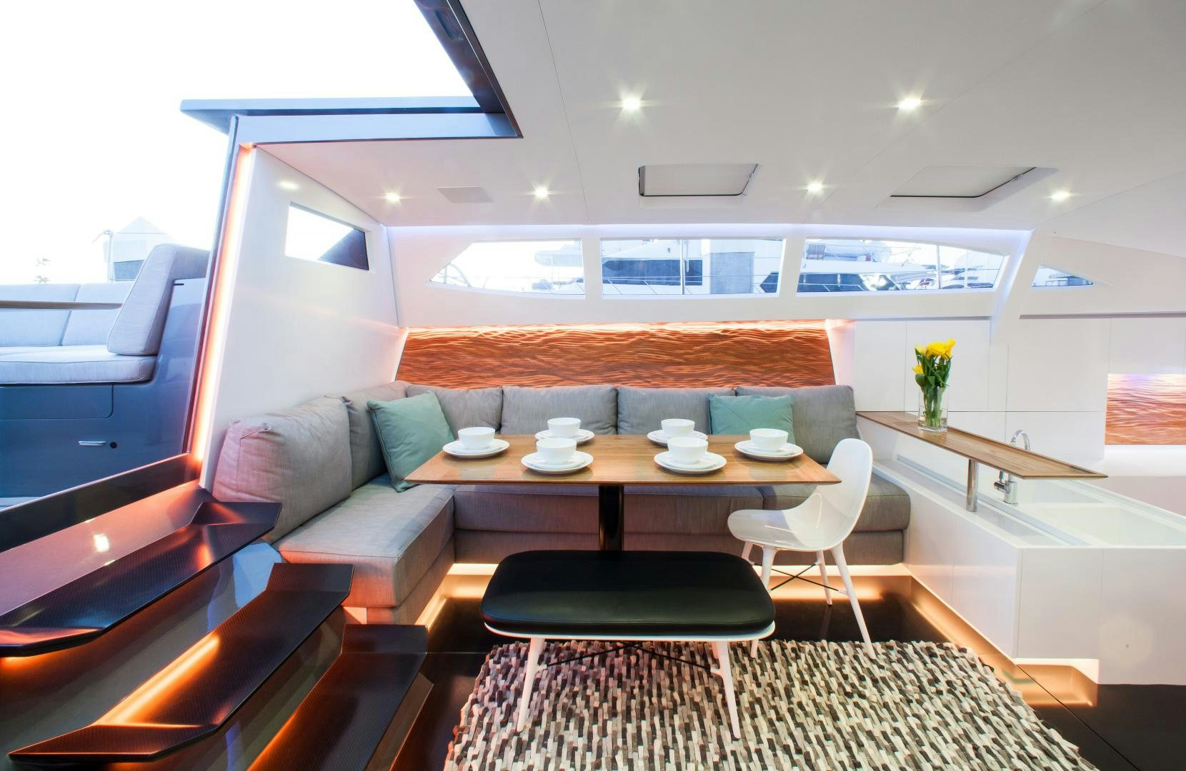 a room with a table and chairs aboard AANDEEL Yacht for Sale