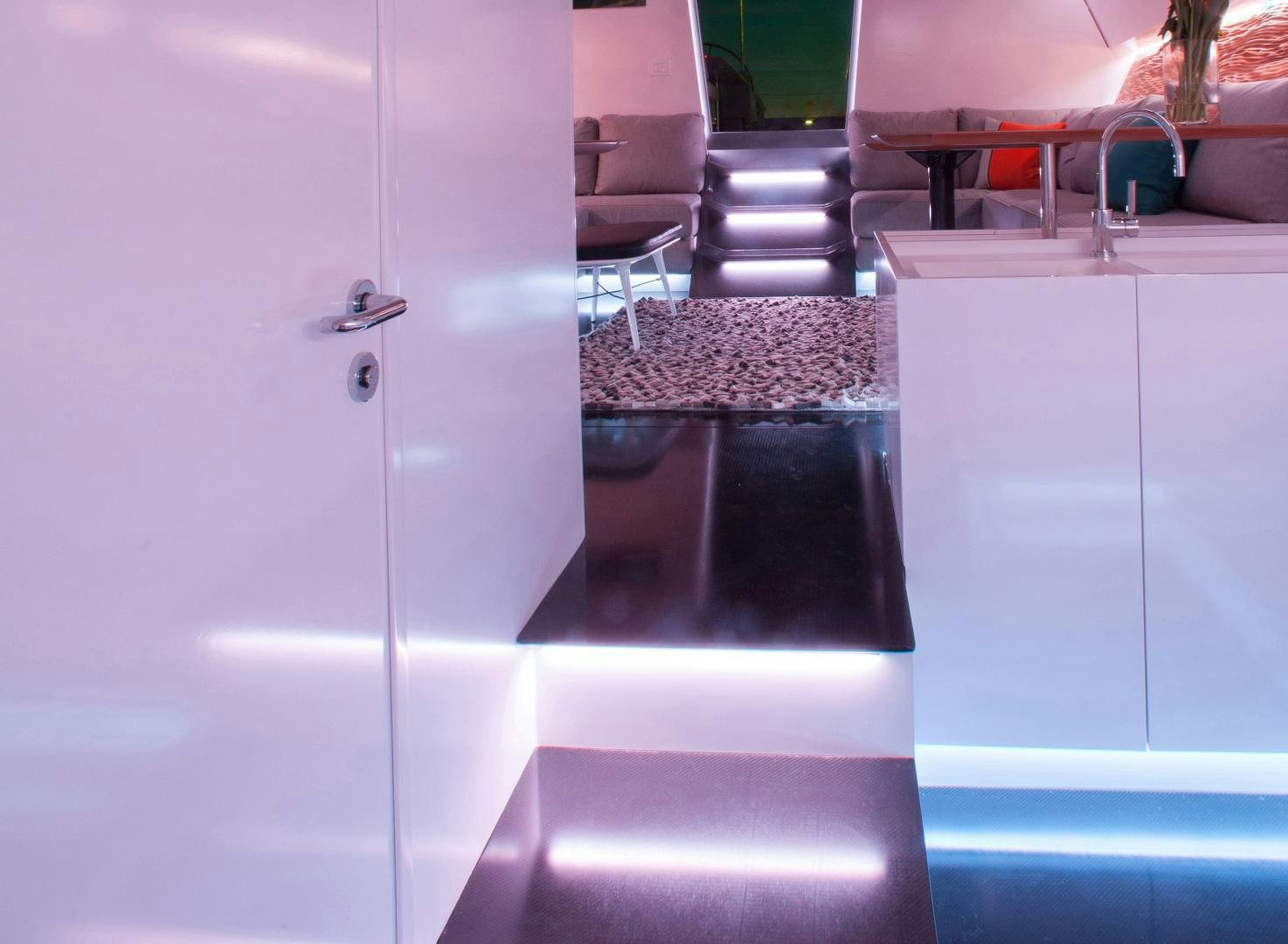 a white kitchen with a black counter aboard AANDEEL Yacht for Sale