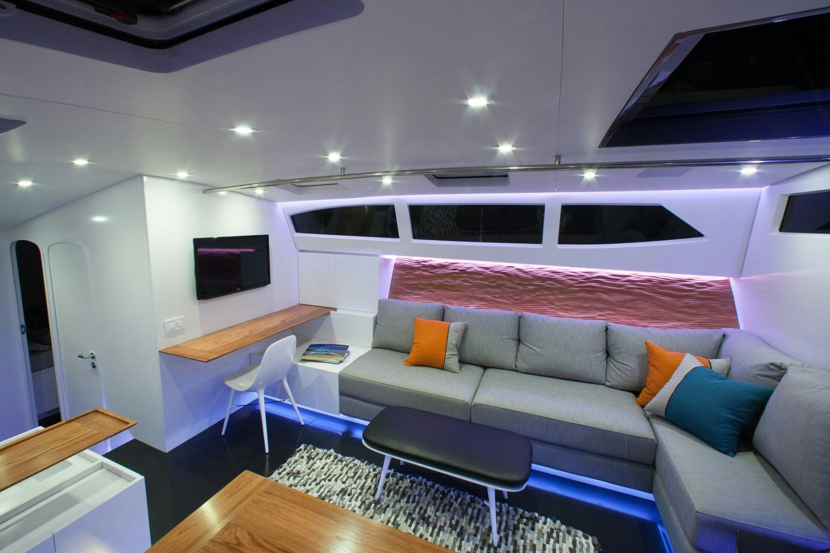 a living room with a couch and a table aboard AANDEEL Yacht for Sale
