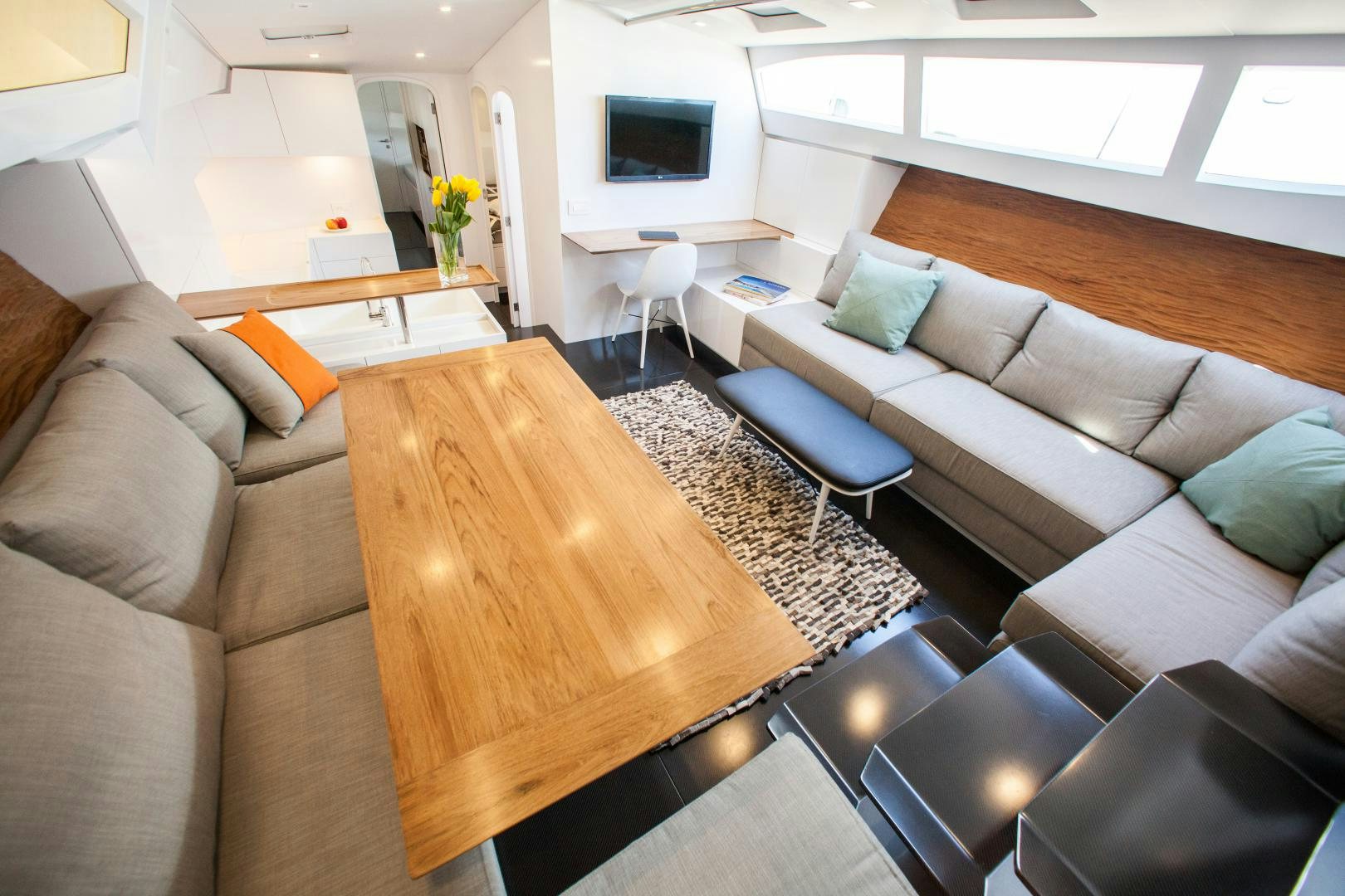 a living room with a couch and a coffee table aboard AANDEEL Yacht for Sale