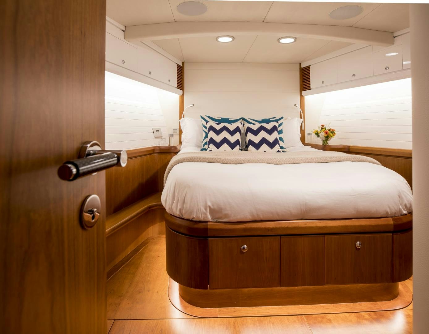 a bed with blue and white pillows aboard aglaia Yacht for Sale