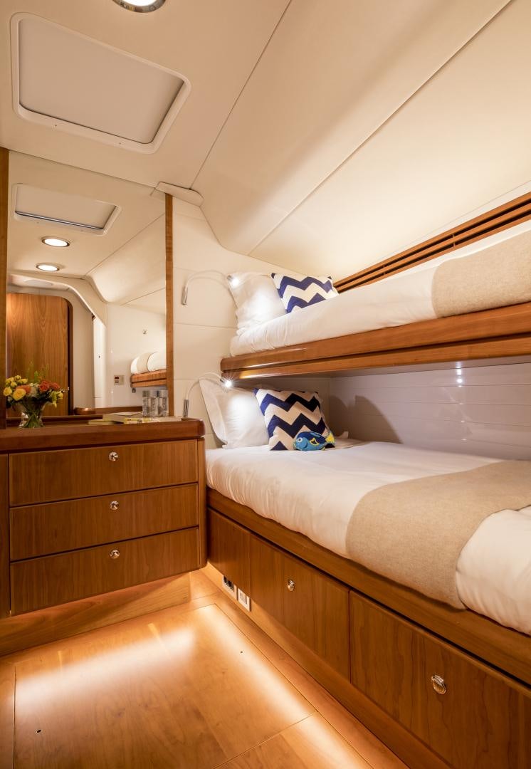 a bedroom with a bed and a mirror aboard aglaia Yacht for Sale
