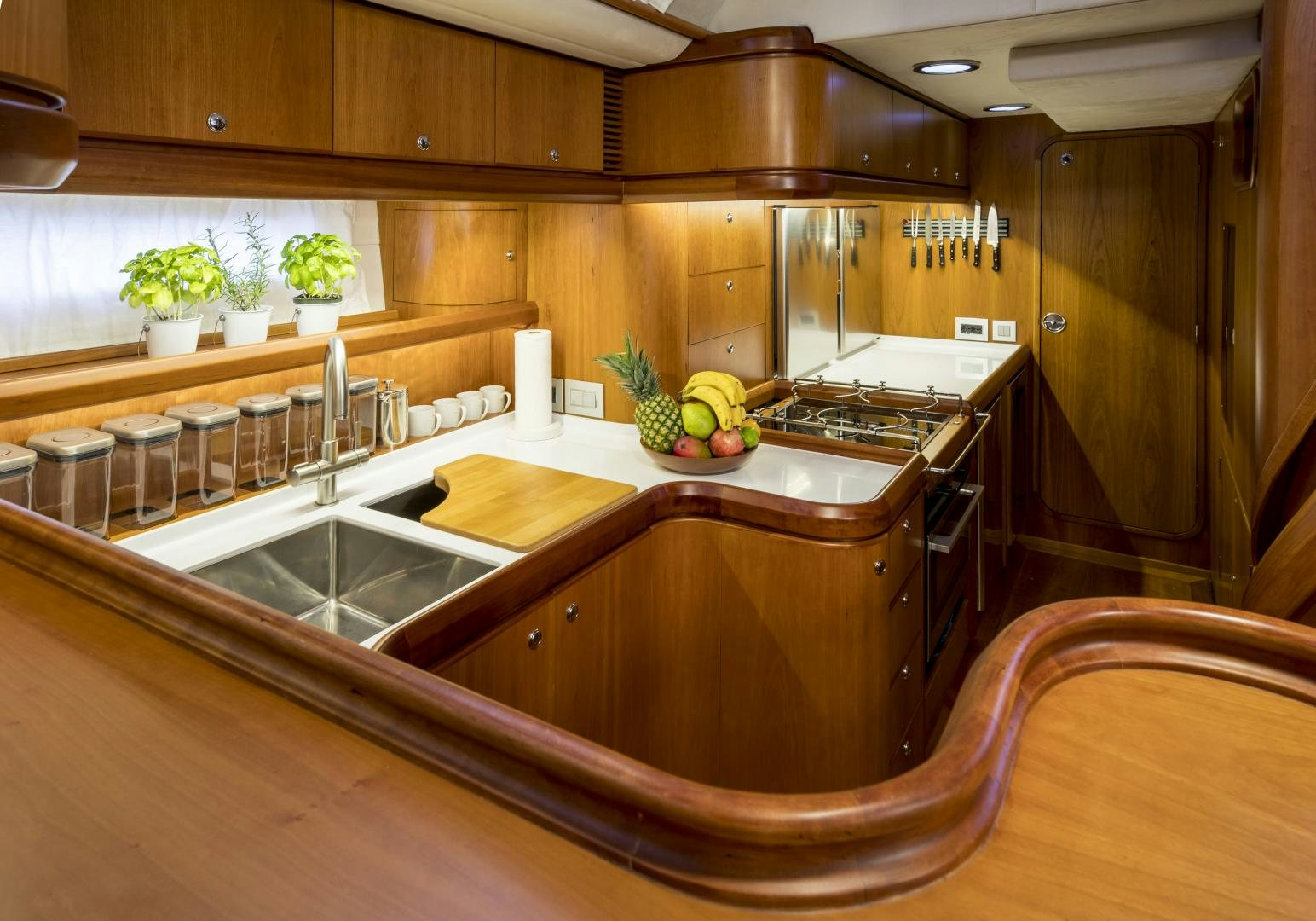 a kitchen with wooden cabinets aboard aglaia Yacht for Sale
