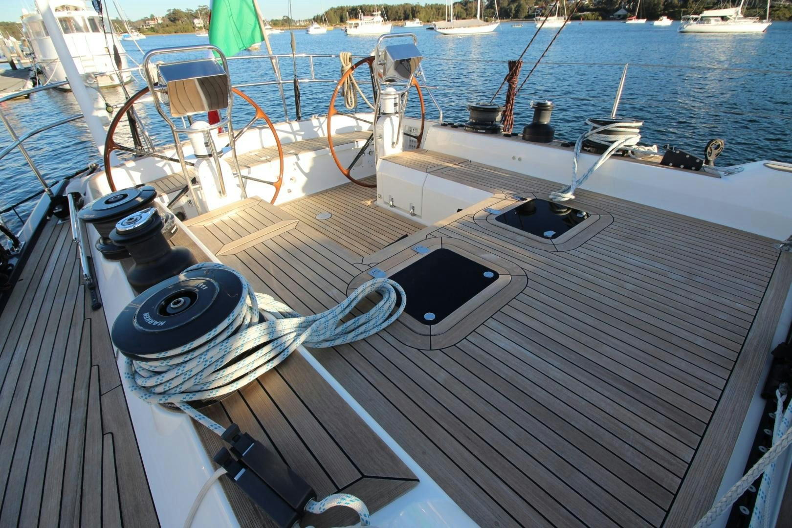 a deck with a boat and a chair on it aboard kiamar Yacht for Sale