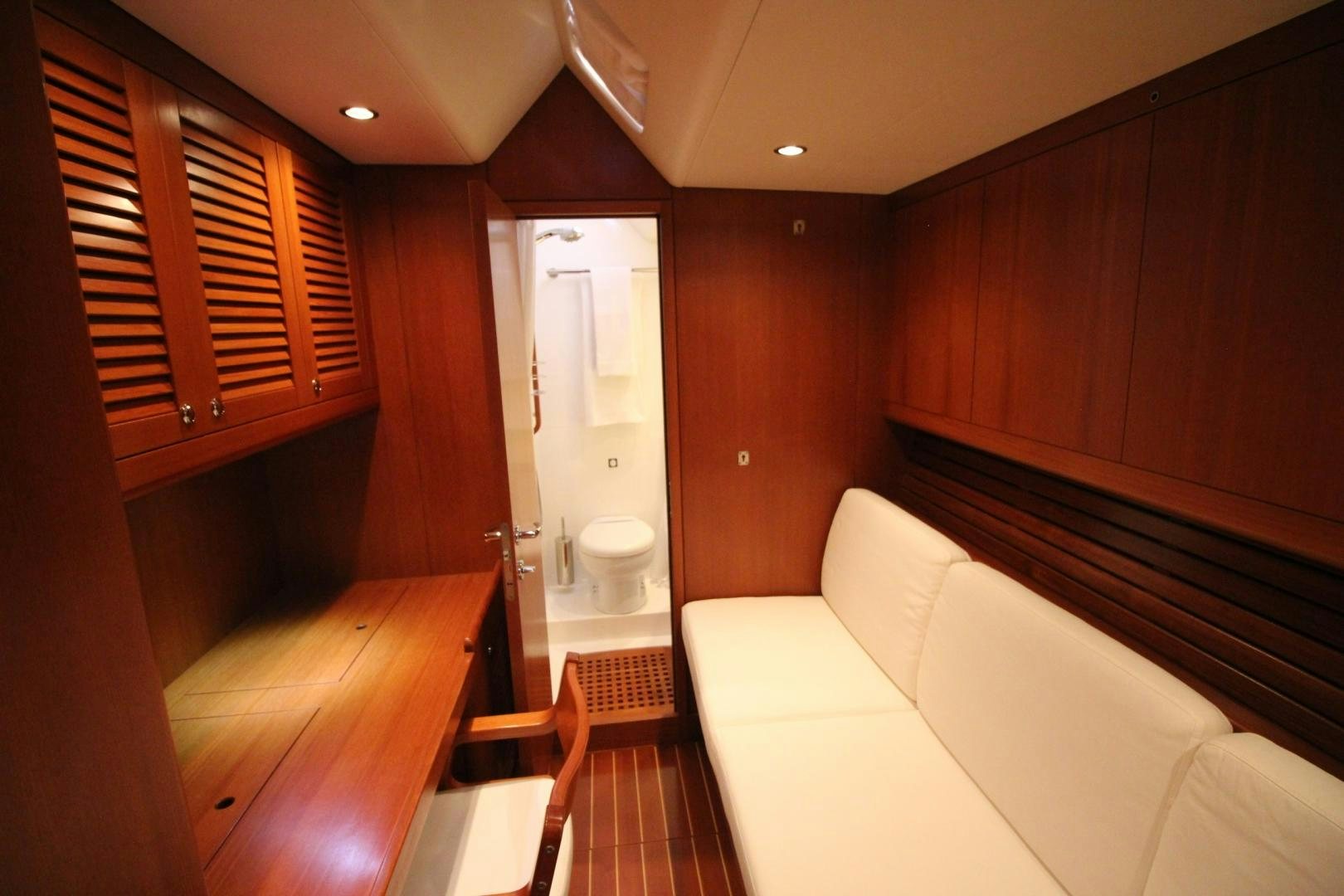 a room with a bed and a couch aboard kiamar Yacht for Sale