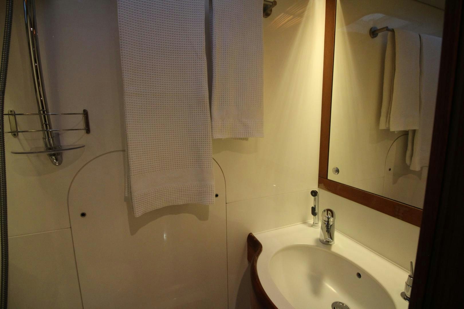a bathroom with a sink and a mirror aboard kiamar Yacht for Sale