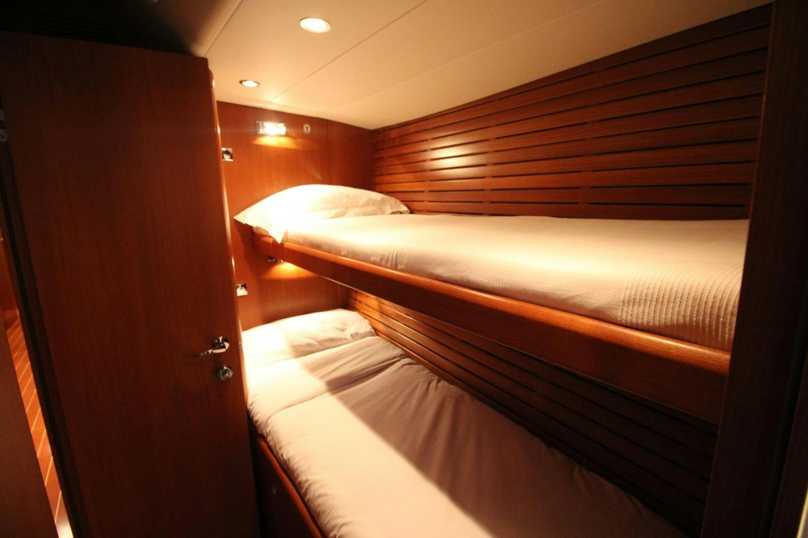 a room with a bed and a wood door aboard kiamar Yacht for Sale