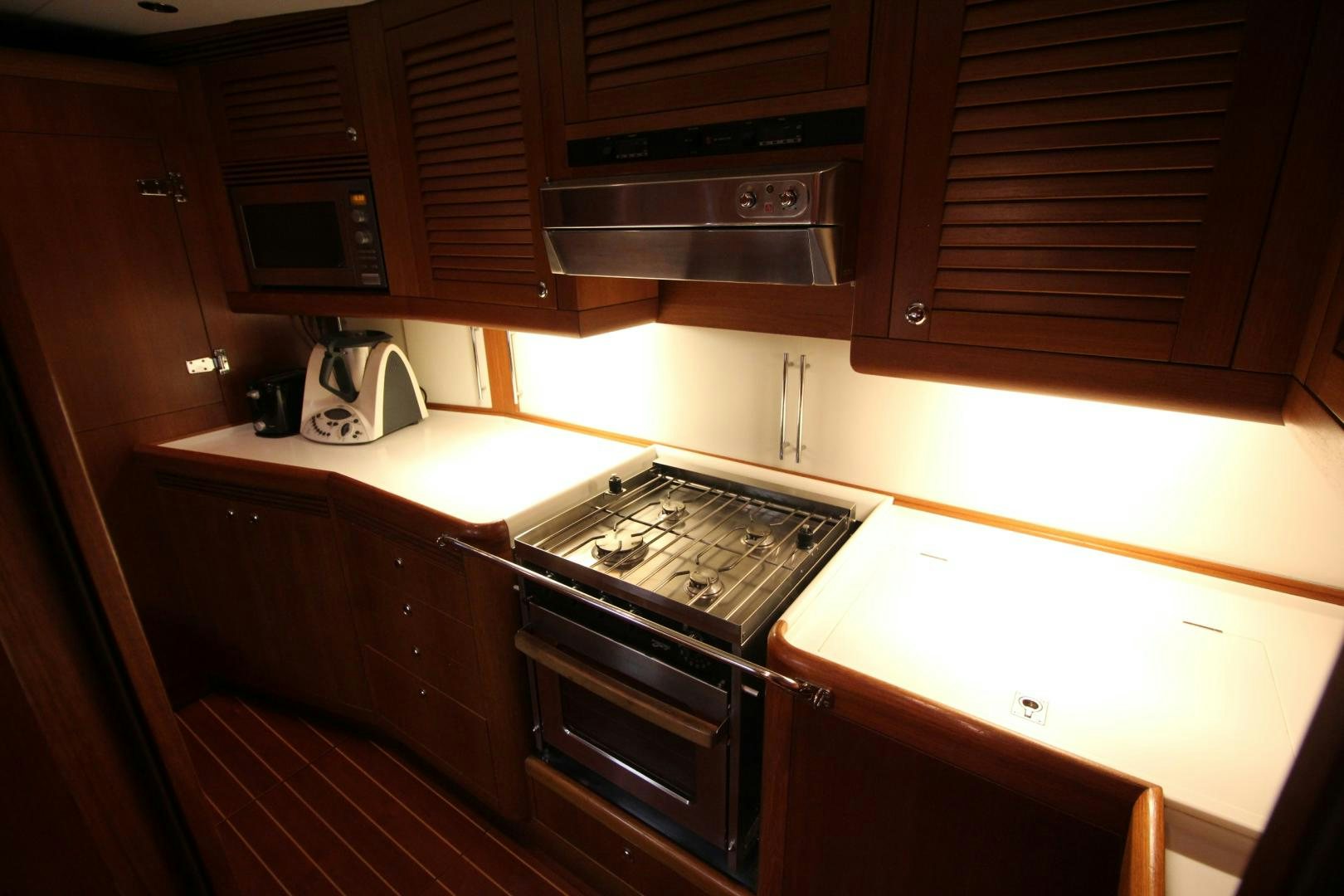 a kitchen with wooden cabinets aboard kiamar Yacht for Sale