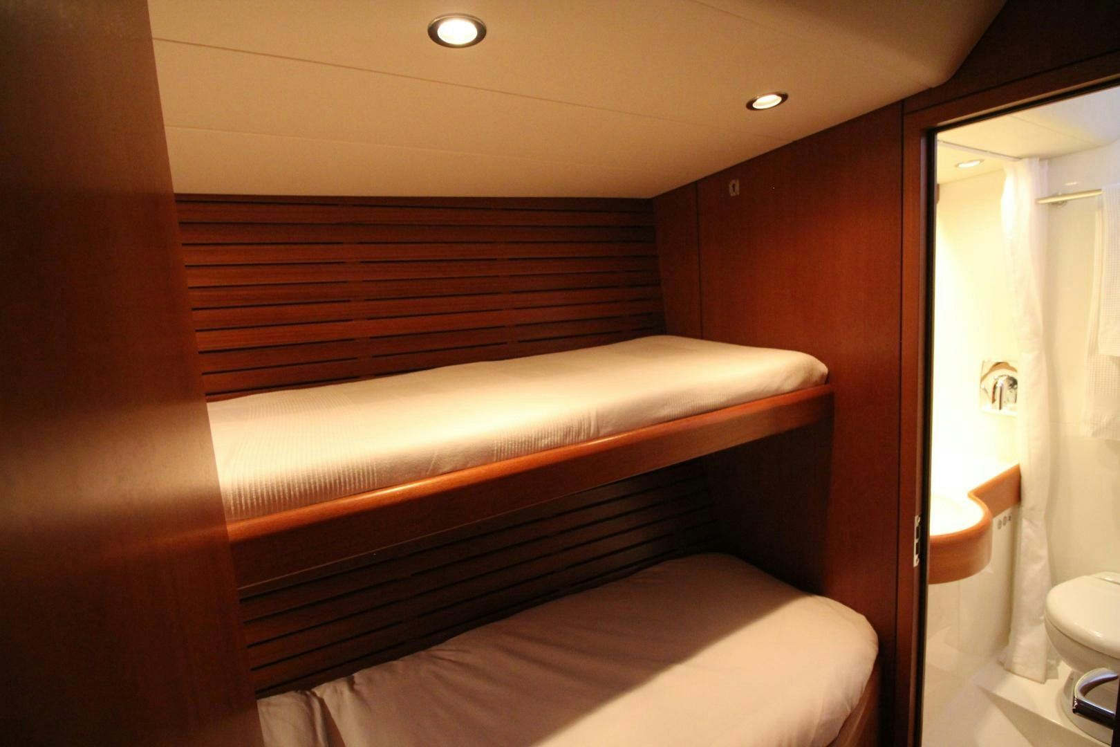 a bedroom with a bed and a shower aboard kiamar Yacht for Sale