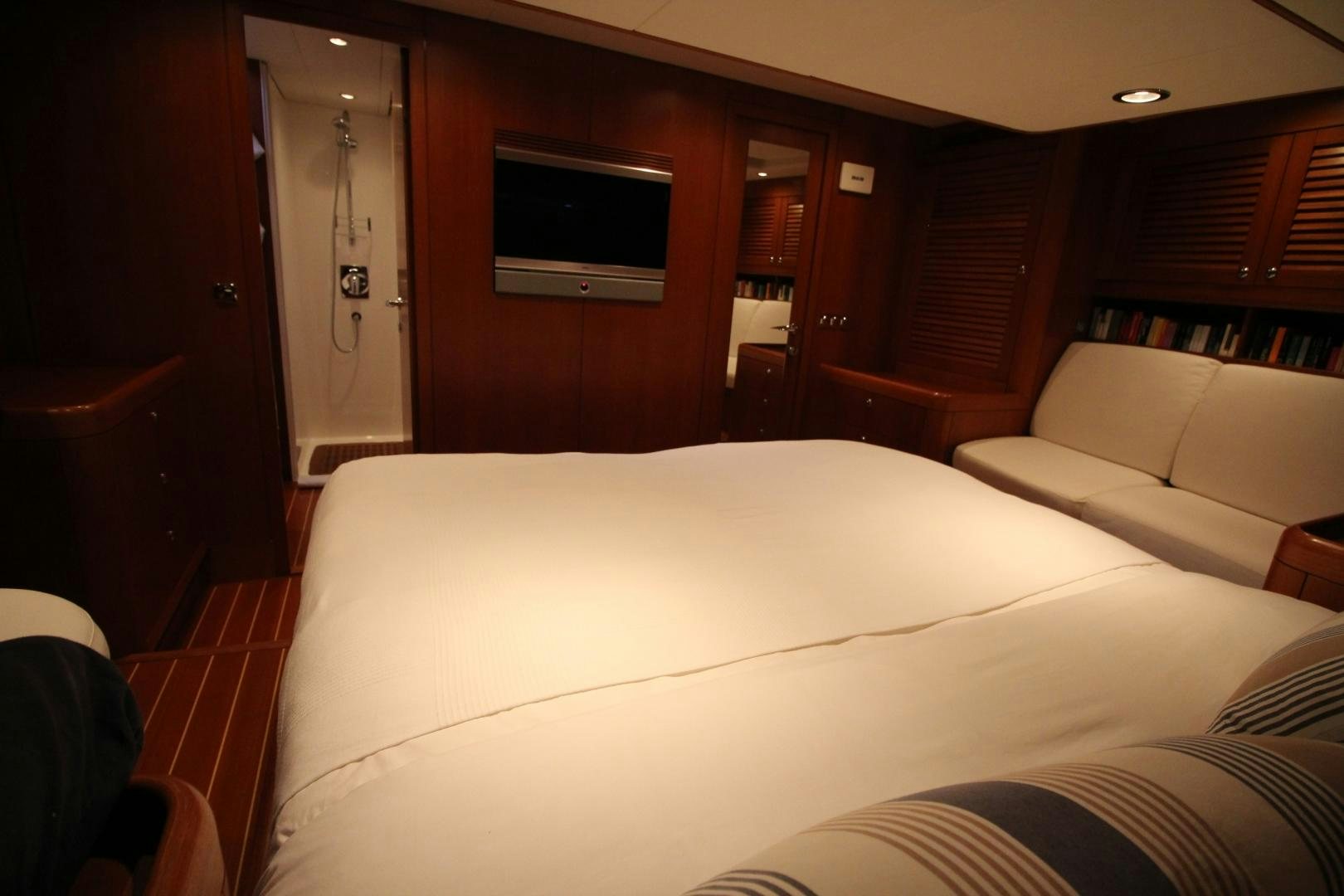 a room with a bed and a television aboard kiamar Yacht for Sale