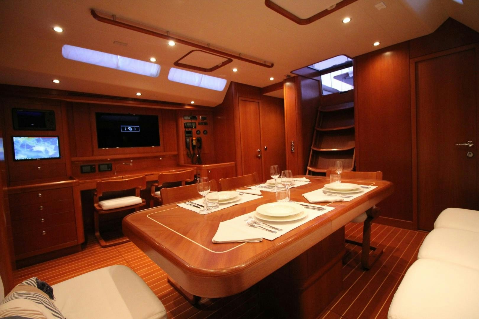 a room with a table and chairs aboard kiamar Yacht for Sale