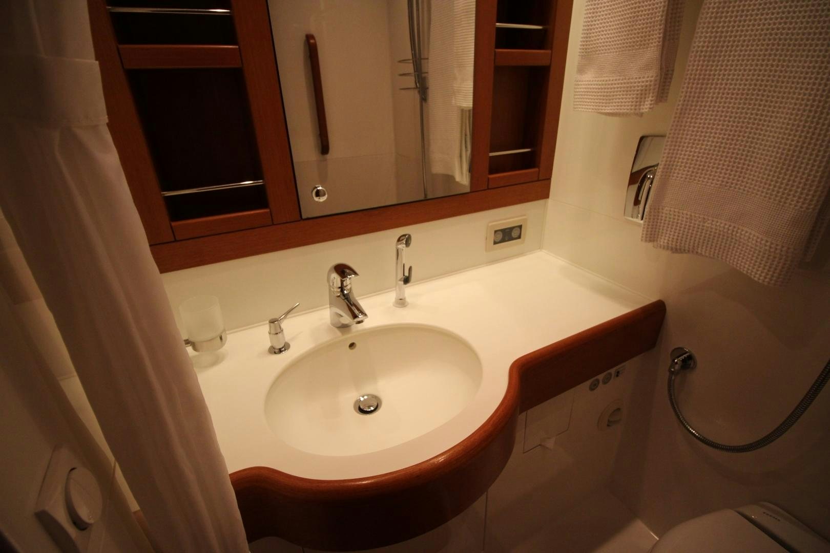a bathroom with a sink and mirror aboard kiamar Yacht for Sale