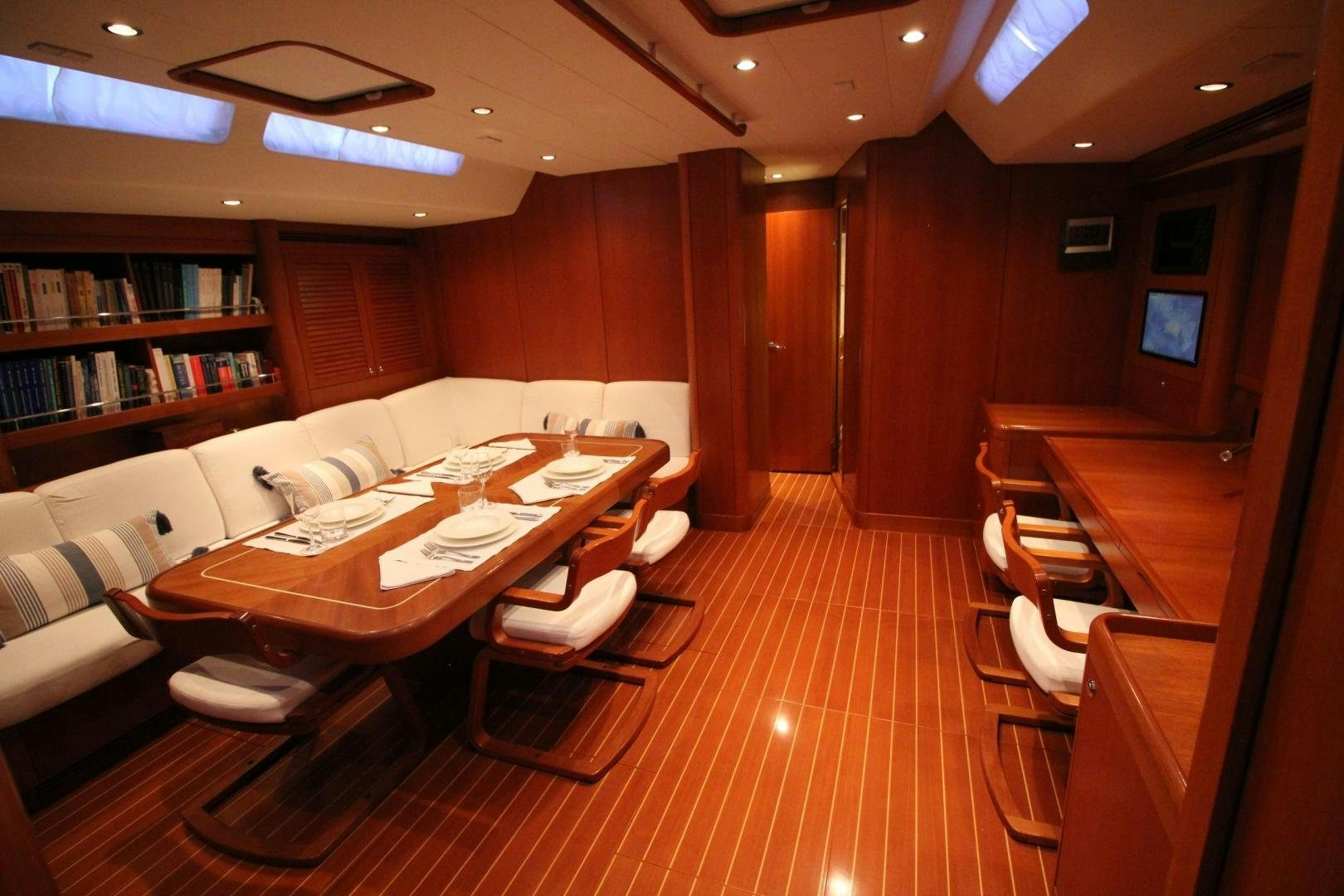 a room with a table and chairs aboard kiamar Yacht for Sale