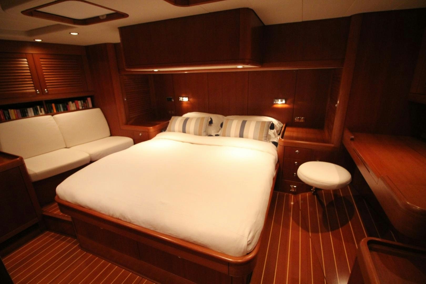 a room with a bed and a chair aboard kiamar Yacht for Sale