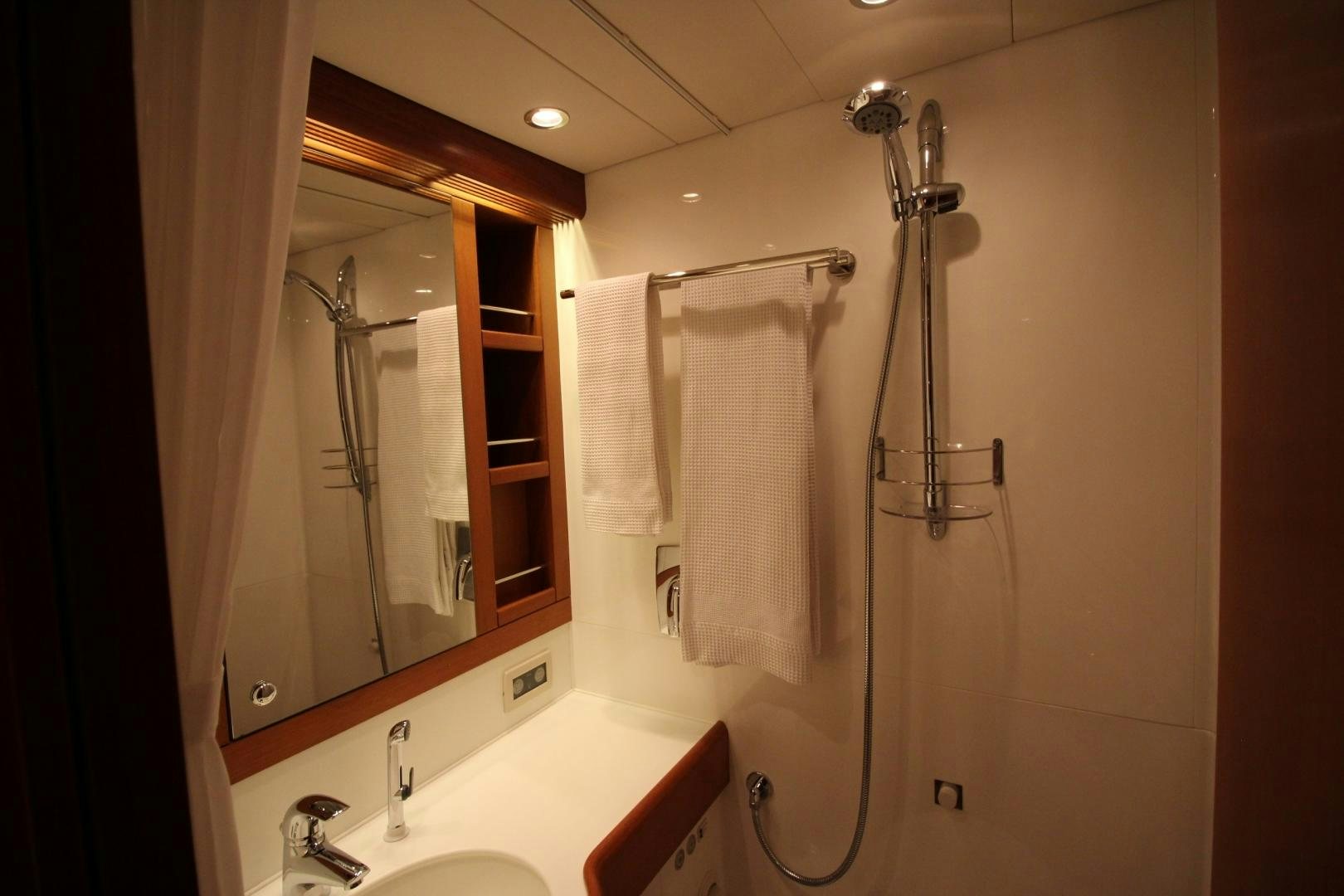 a bathroom with a shower unit and a sink aboard kiamar Yacht for Sale
