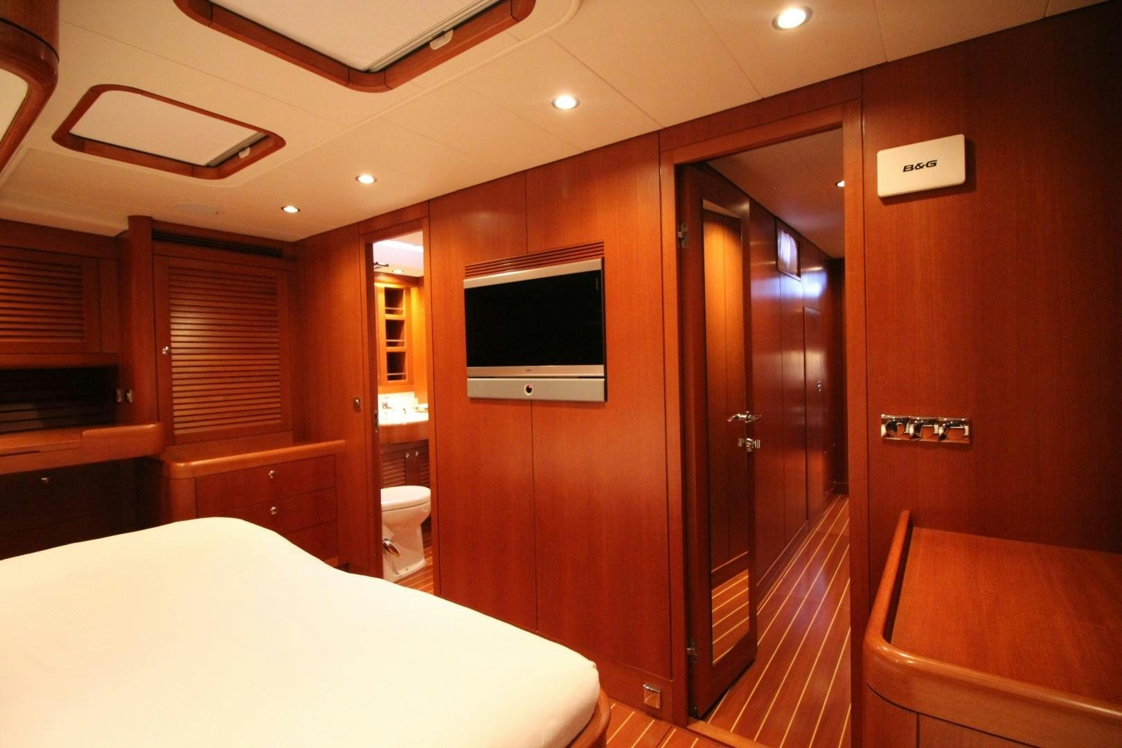 a hotel room with a bed and tv aboard kiamar Yacht for Sale